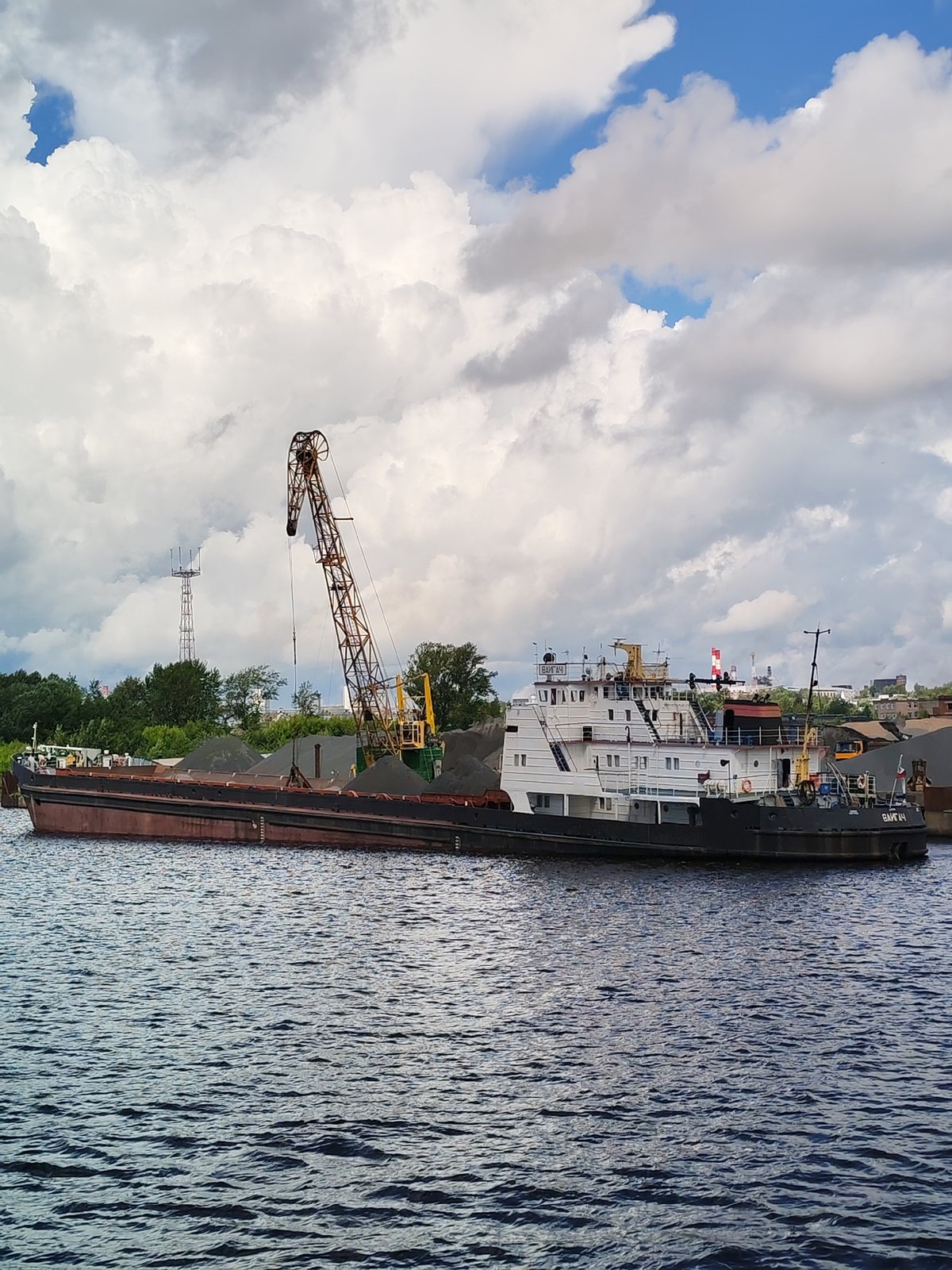 River cruise past a cable-stayed bridge and industrial harbor