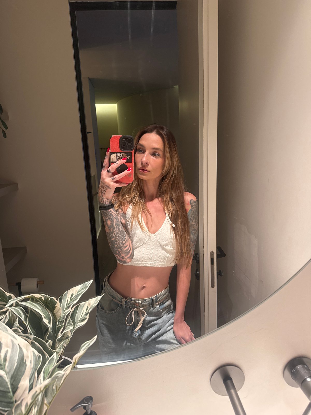 Woman Takes Bathroom Selfies in Modern Tel Aviv Setting