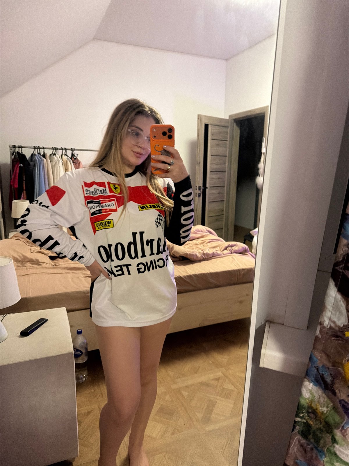 Woman takes mirror selfies in Russian bedroom