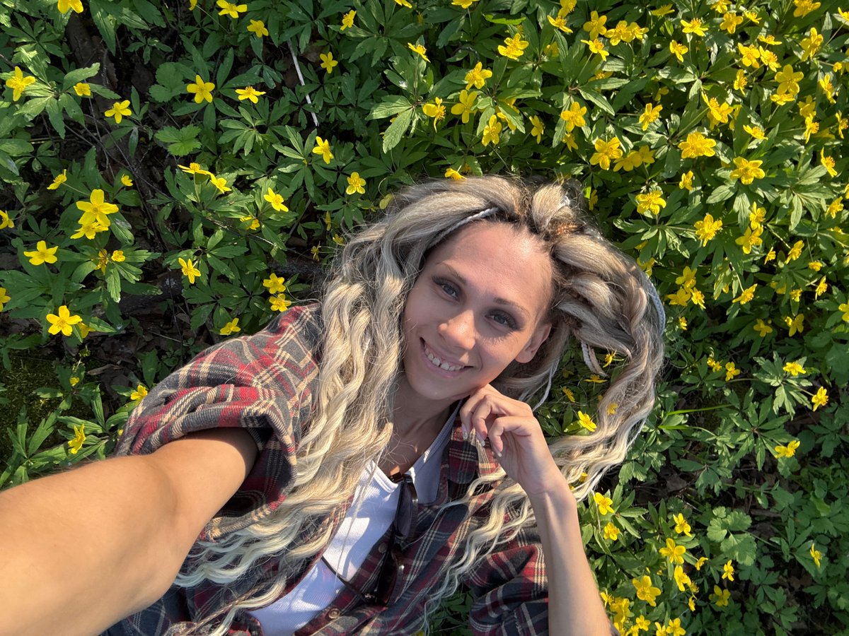 Woman photographed exploring Rusanovo countryside and town during spring afternoon