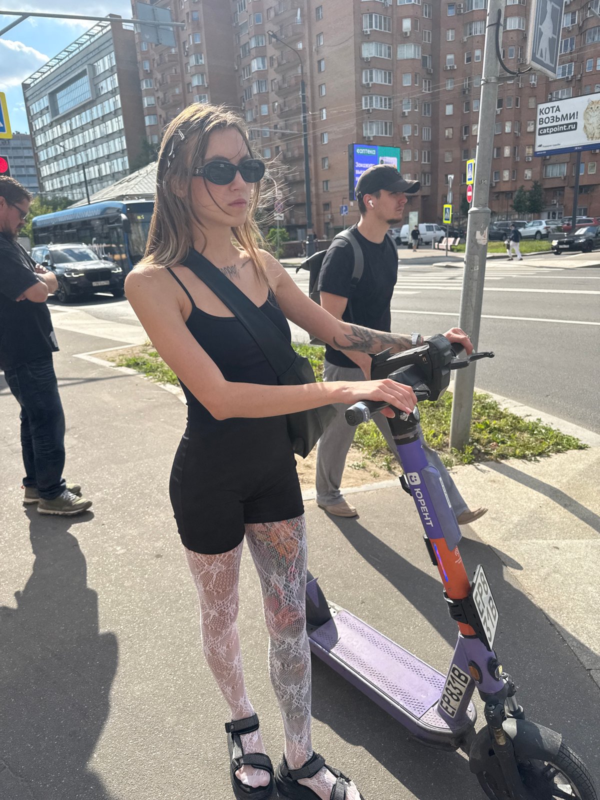 Posing with a colorful electric scooter on a Moscow street