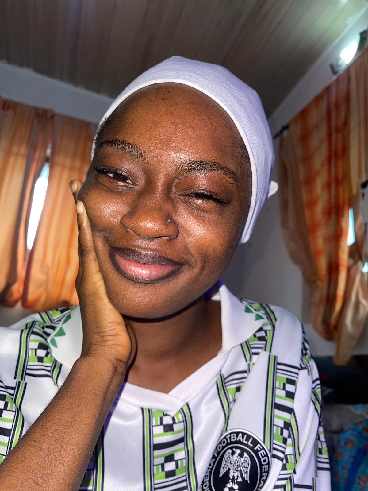 Portraits in Nigeria football kit, Ado