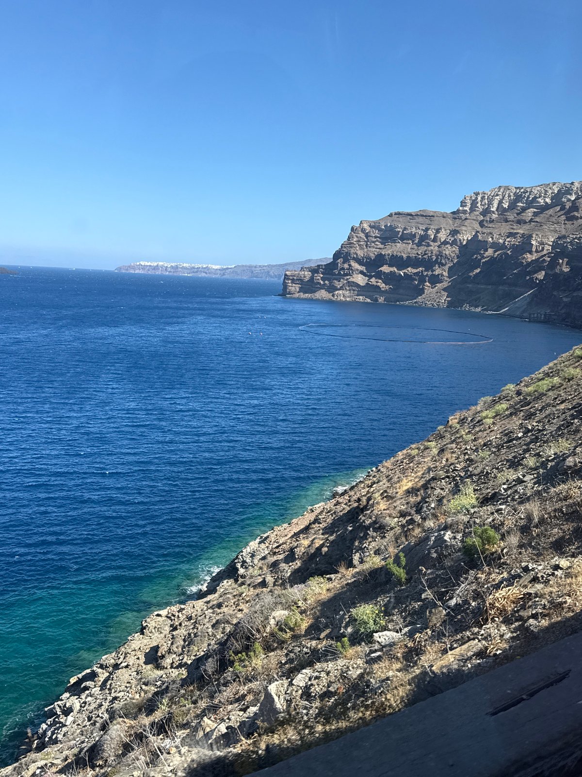 Santorini's cliffs and Aegean waters from two angles