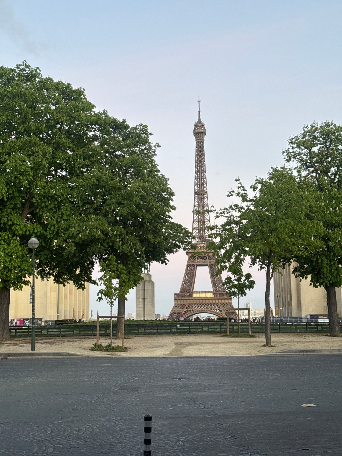 Eiffel Tower viewed from Paris street amid urban landscape