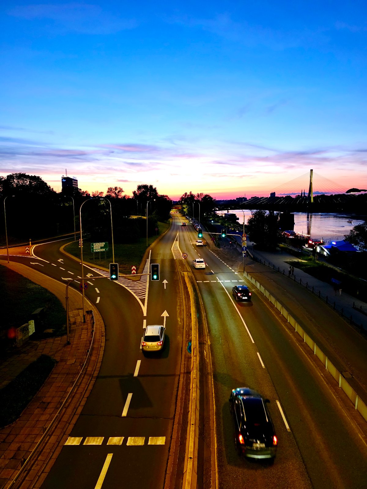 Warsaw's Vistula River glows at dusk on a summer evening