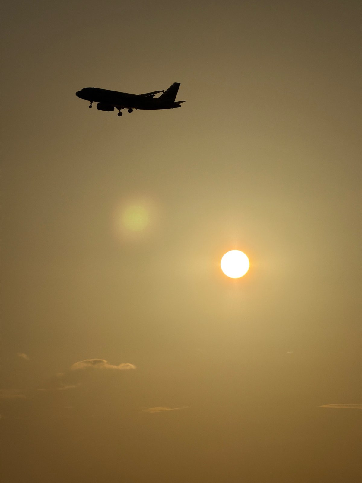 Golden sunset over Ko Samui with a plane on approach