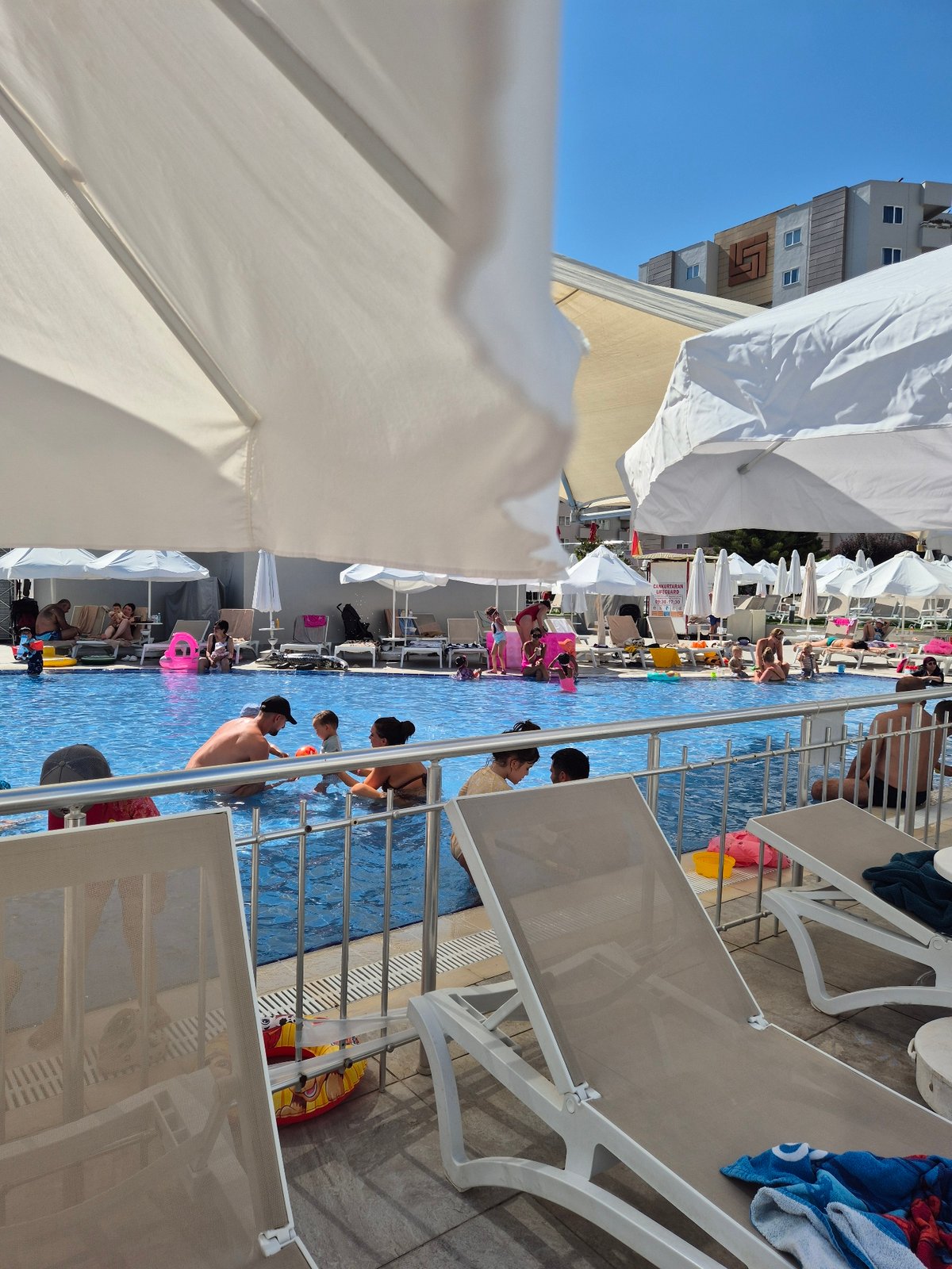 Poolside afternoon: sun, selfies, and a crowded swim session.