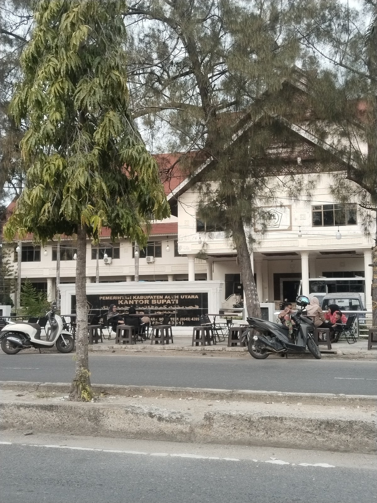 Street life near Lhokseumawe's government district on a cloudy morning