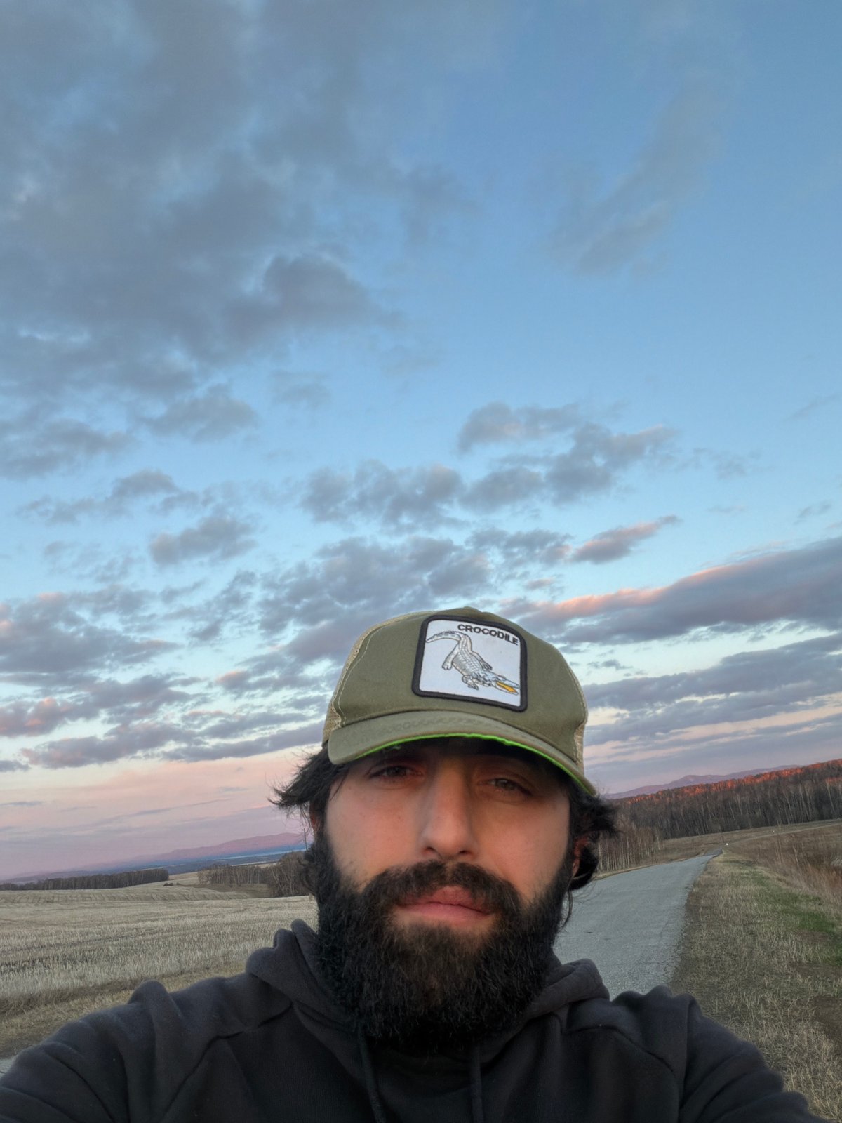 Man takes selfie near harvested field in Chesnoki, Russia