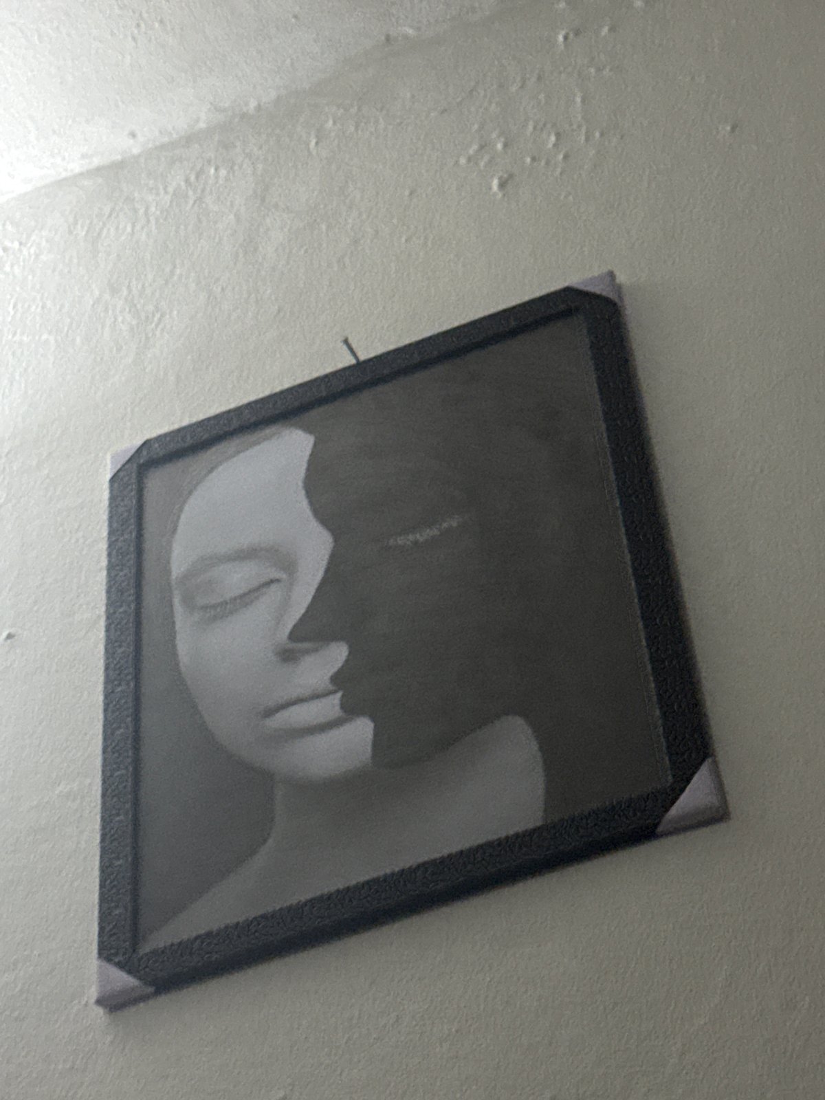 Askew portrait photograph observed on wall in Ihiagwa