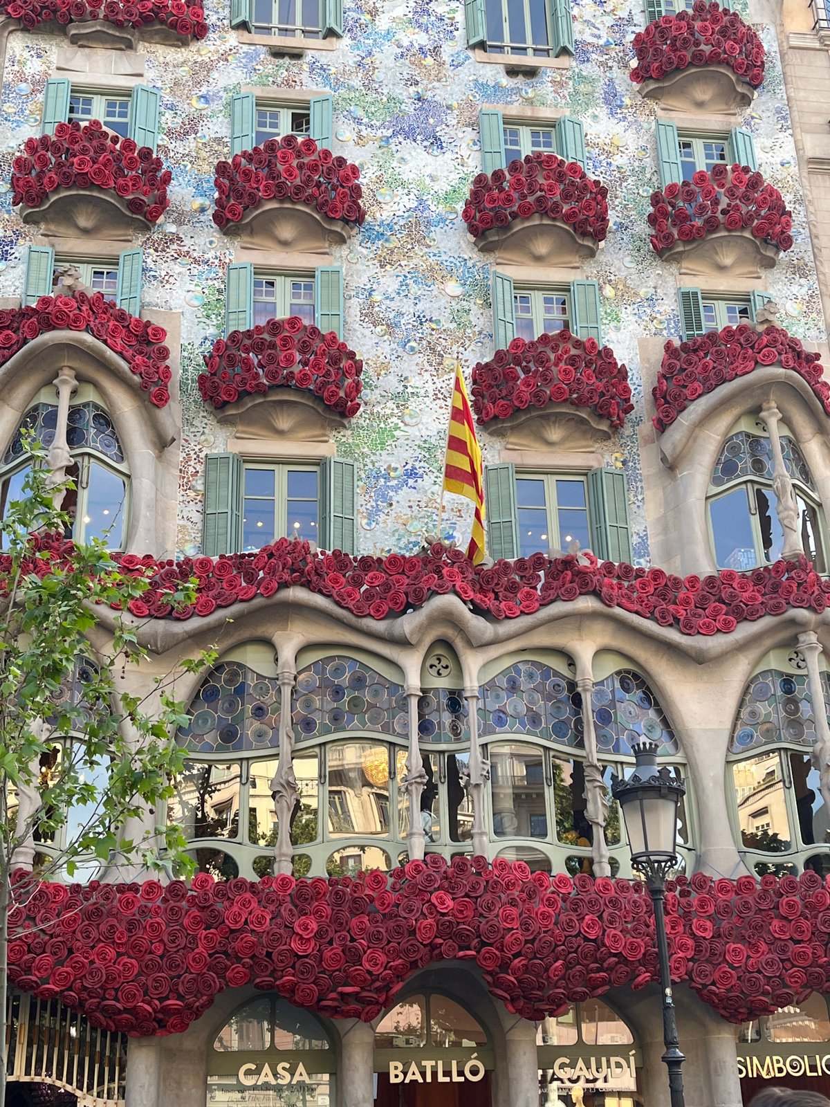Tourist photographs iconic Gaudí building Casa Batlló in Barcelona