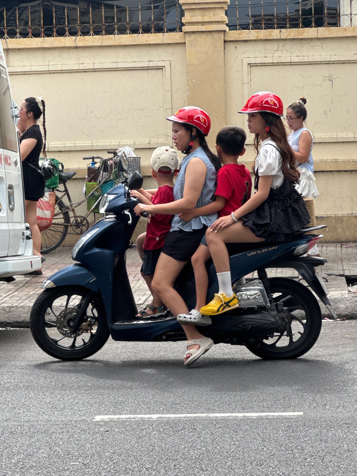 Nha Trang street traffic: scooters, produce, and city skyline