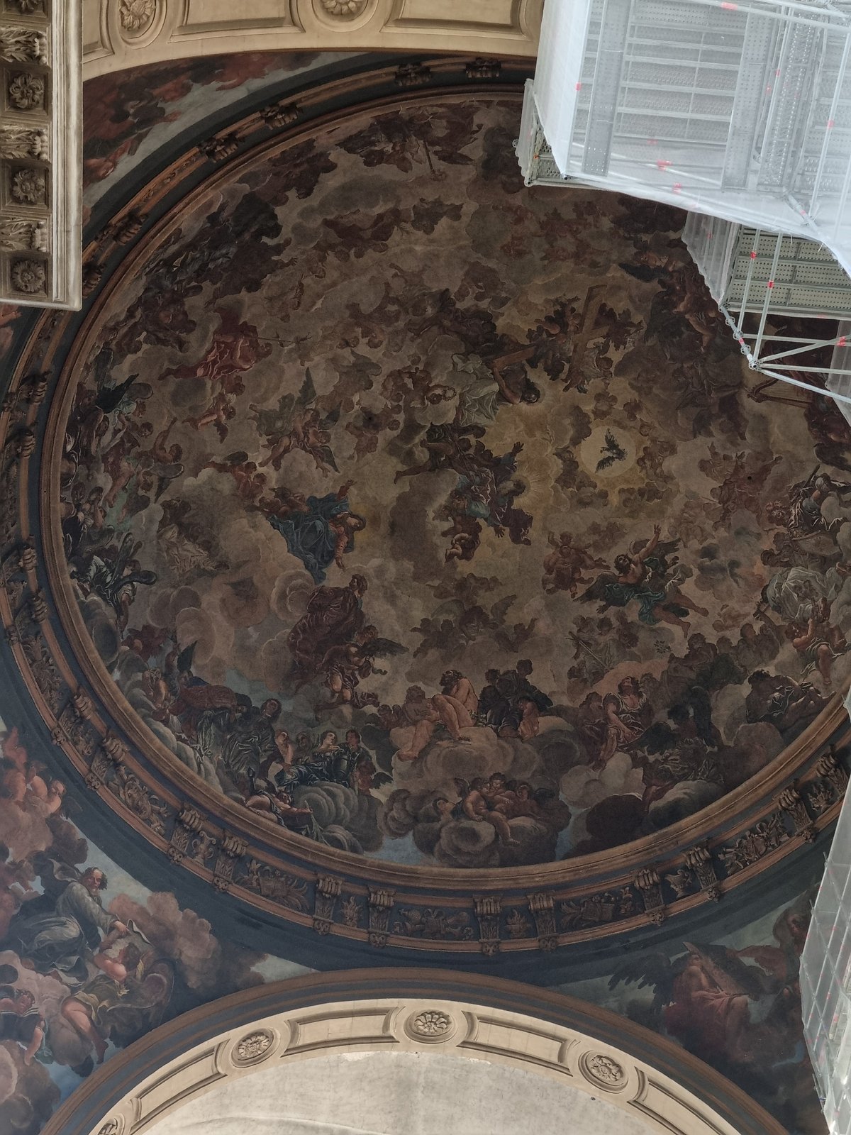 Cathedral interior with ornate frescoes and crucifix documented