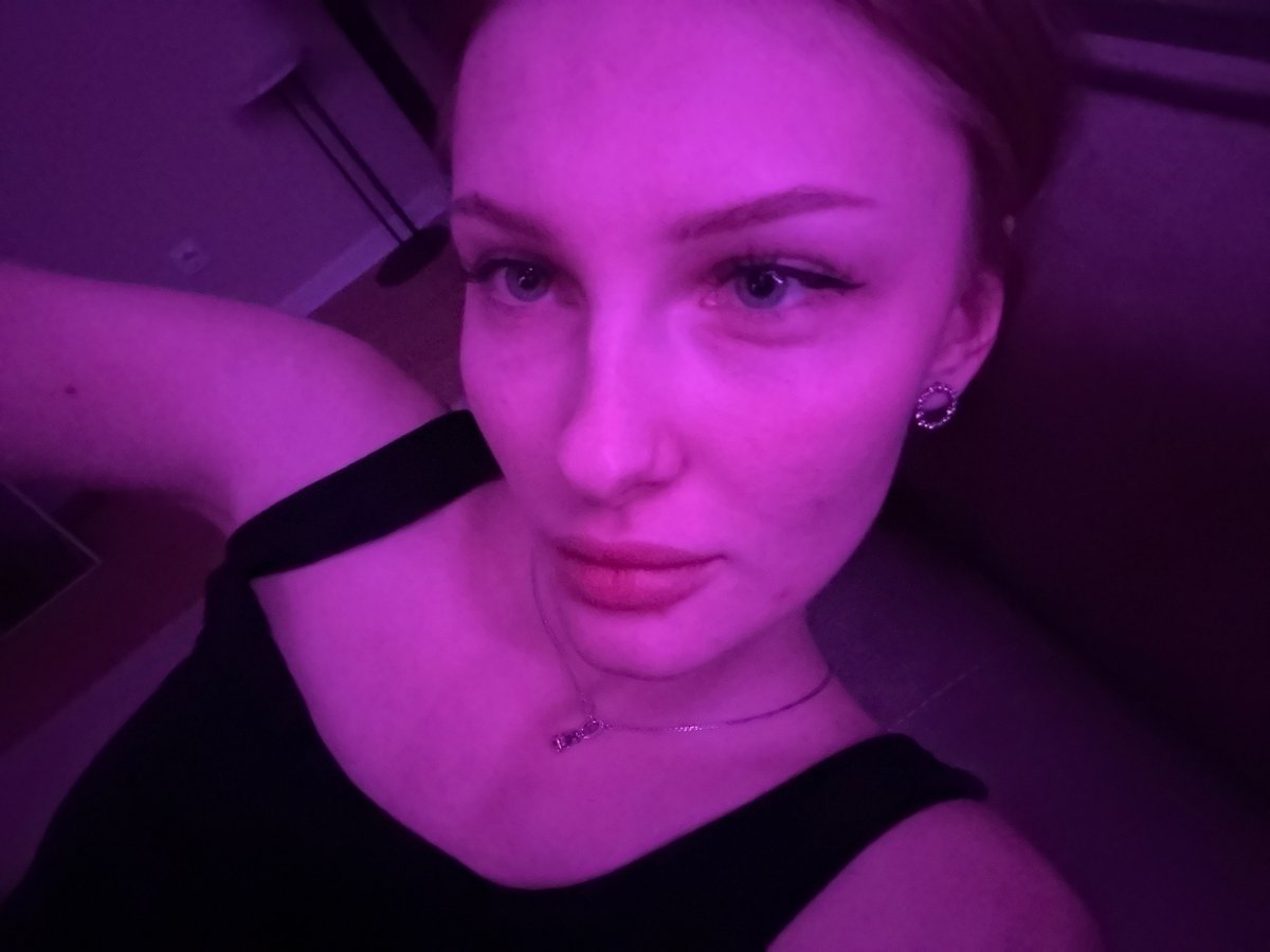 Woman photographed on couch in purple lighting, Perm Russia