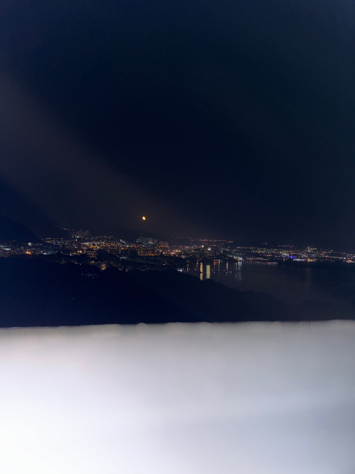 Nighttime panoramic views captured of Kuşadası, Turkey coastal cityscape