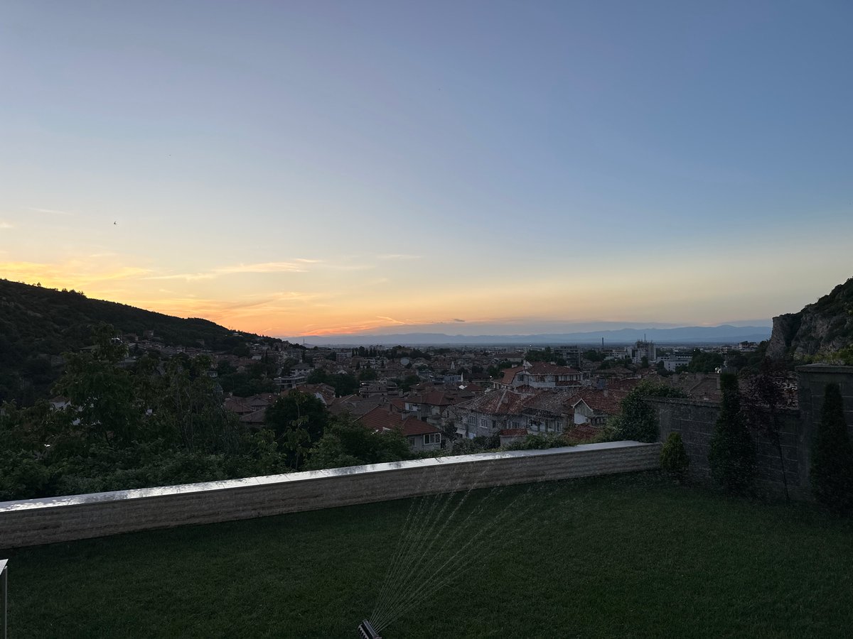 Sunset dinner setting overlooking Asenovgrad with Pomeranian companion