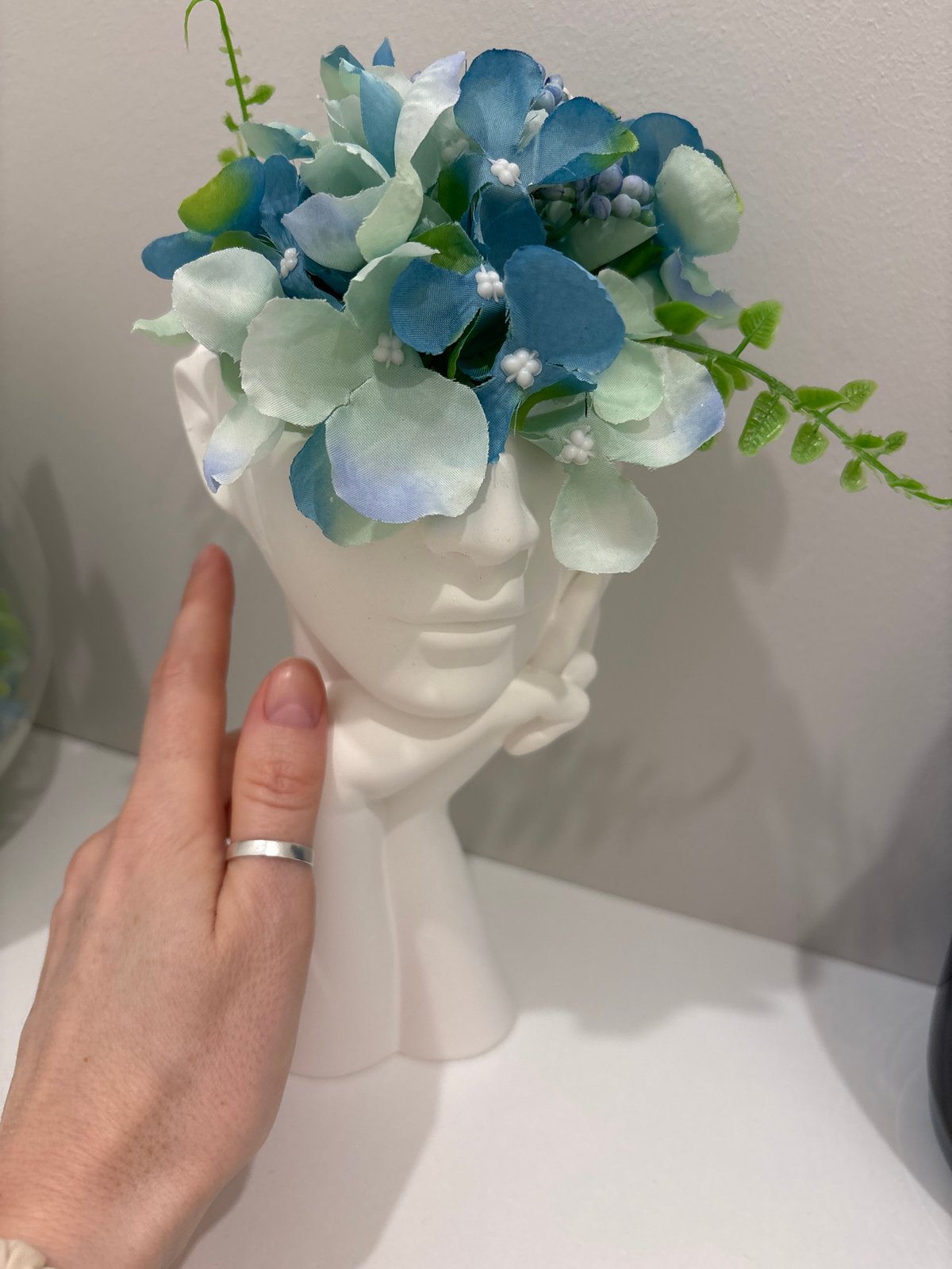 Woman documents flower arrangement and selfies in Saint Petersburg