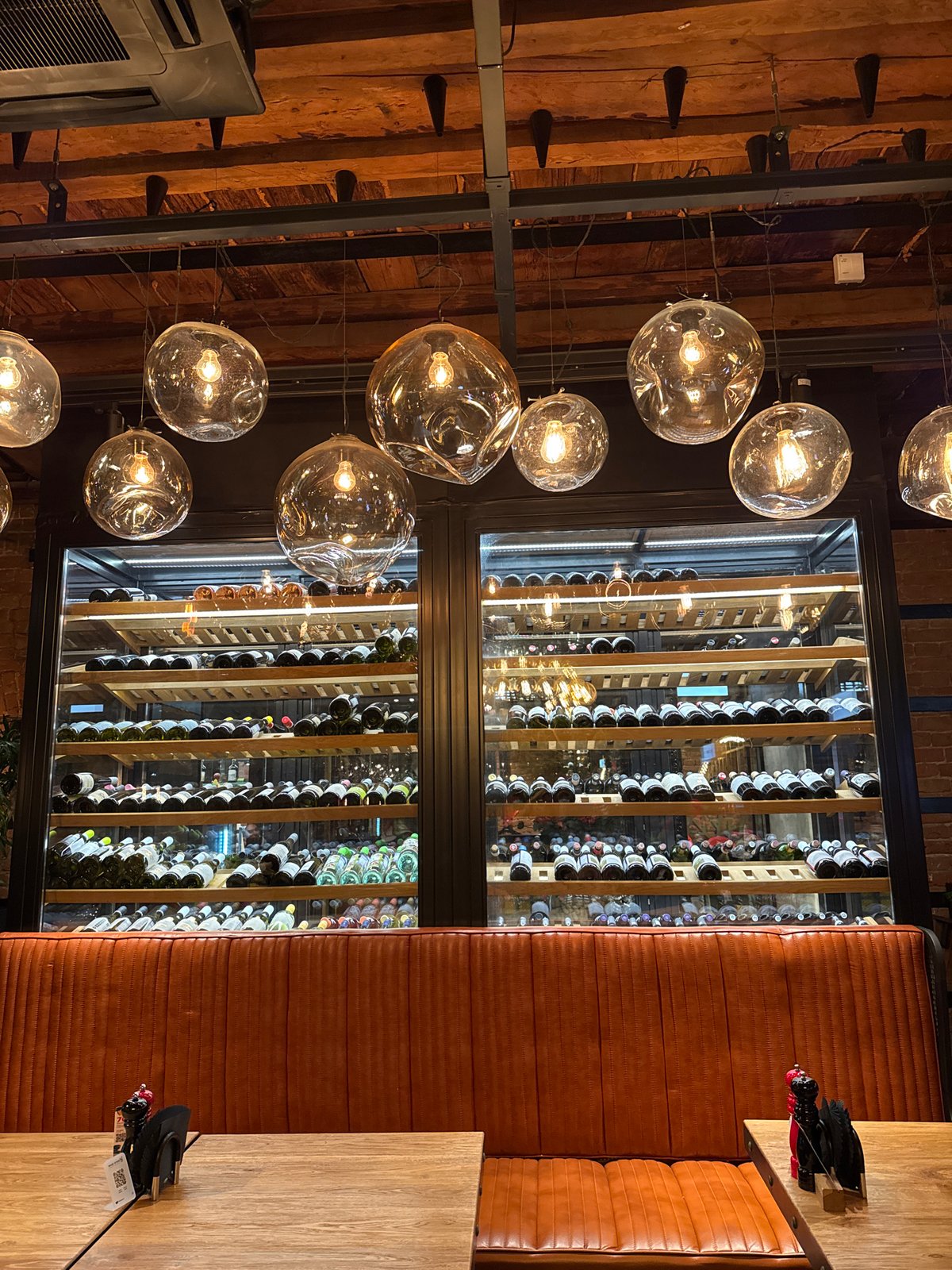 Restaurant bar interior captured with wine rack and entertainment features