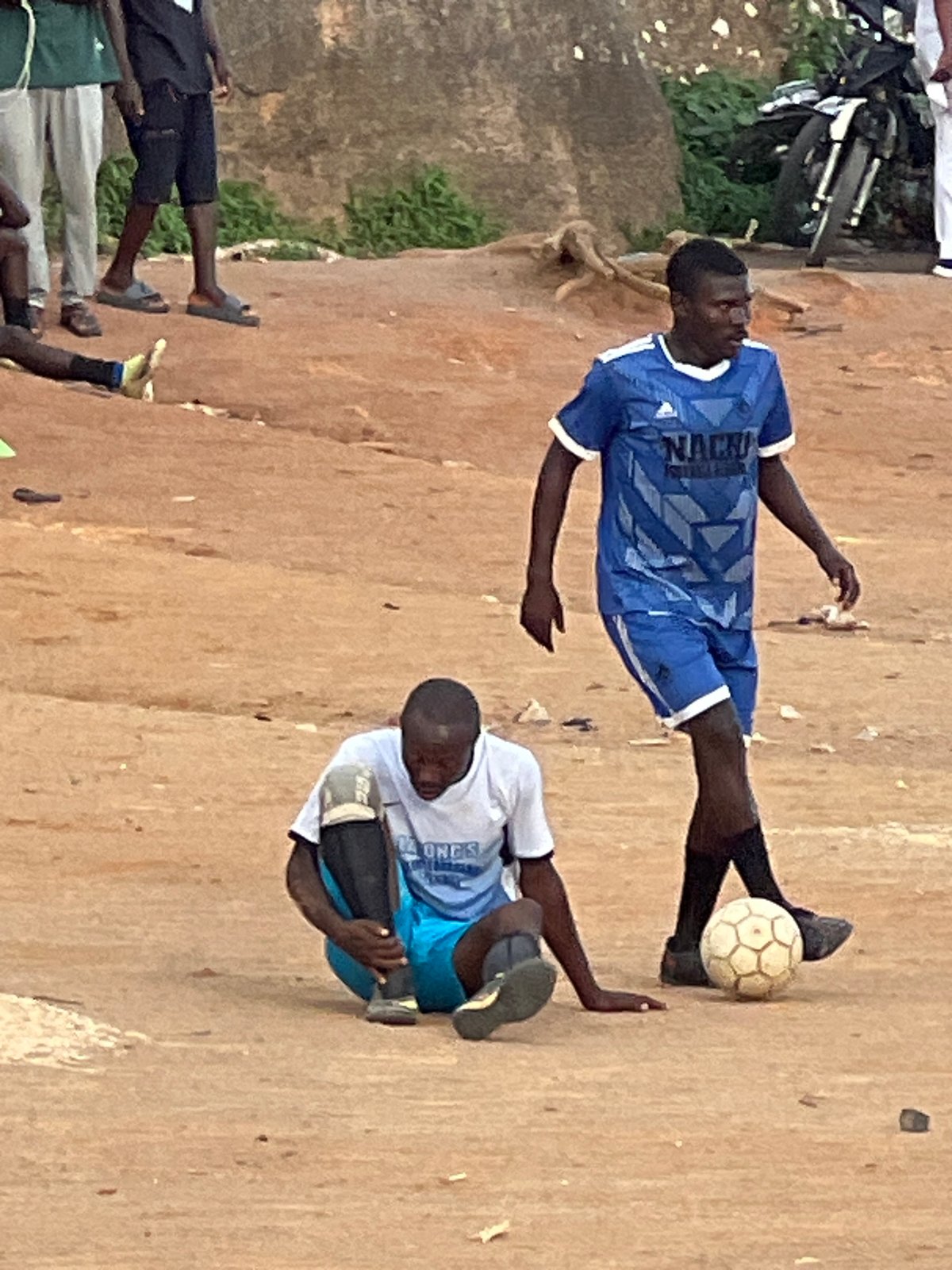 Afternoon football match on a dusty pitch in Jos, Nigeria
