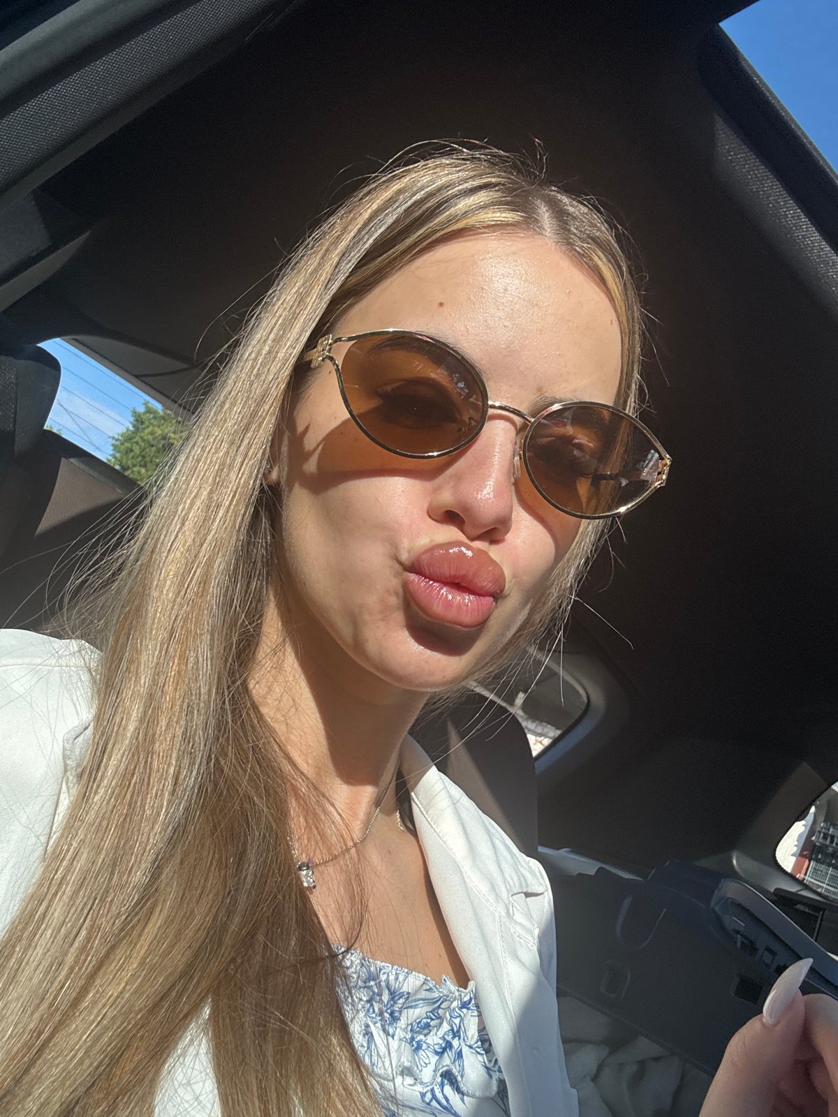 Woman takes morning car selfies in Ilindentsi, Bulgaria