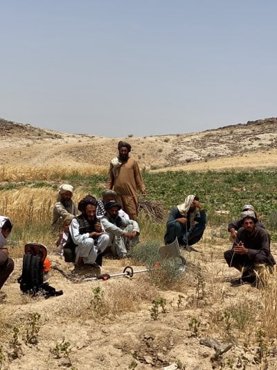Rural gathering of men and child in agricultural area