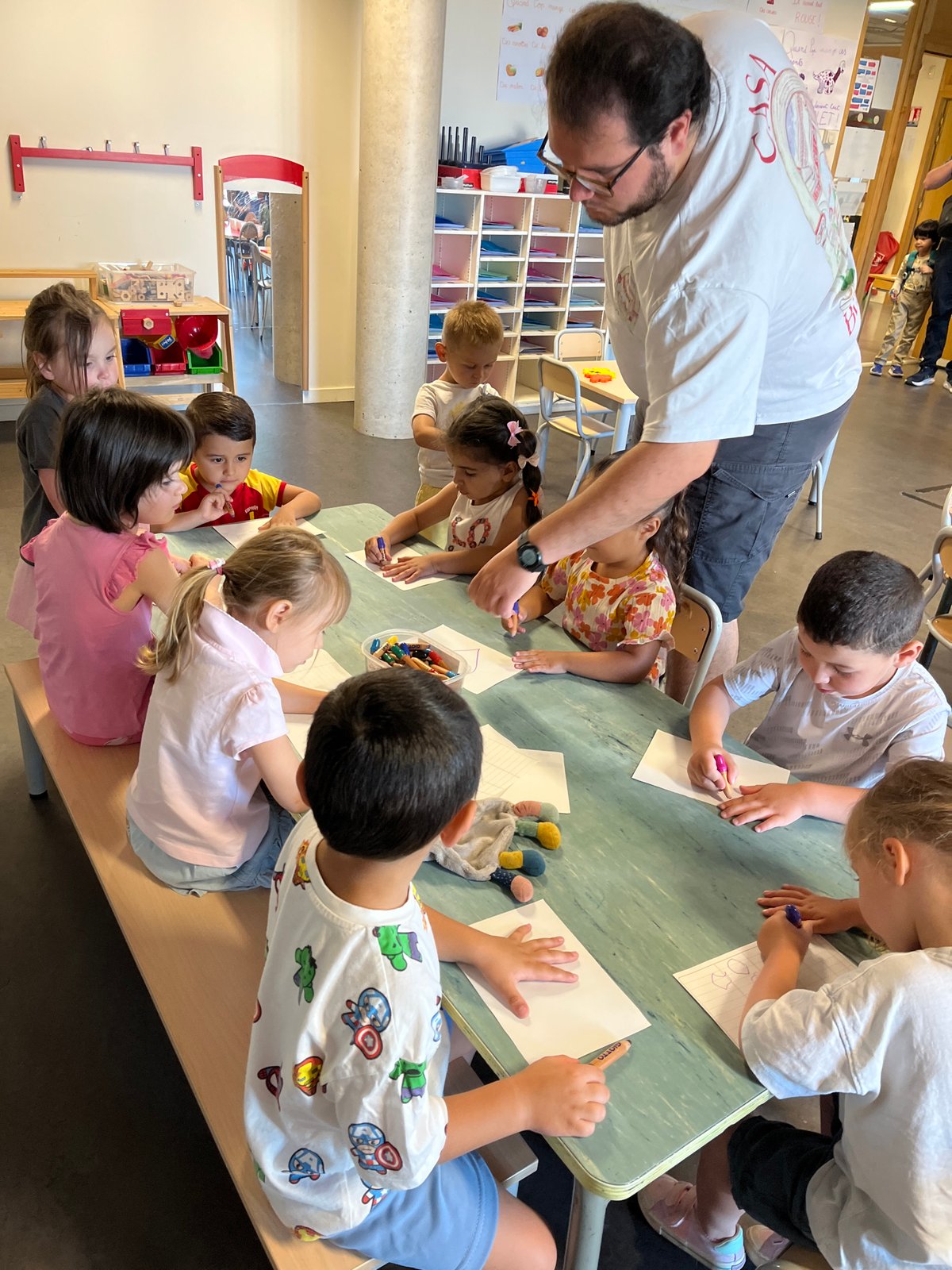 Children engage in supervised art activity in La Fouillouse classroom