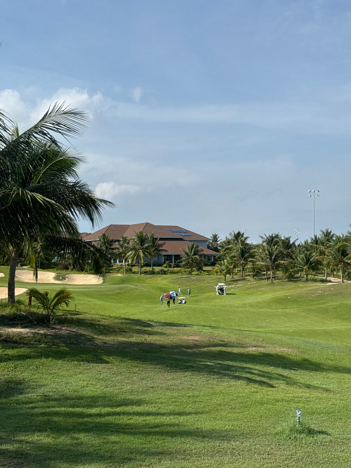 Golf round in progress at a tropical resort course, Phú Thủy