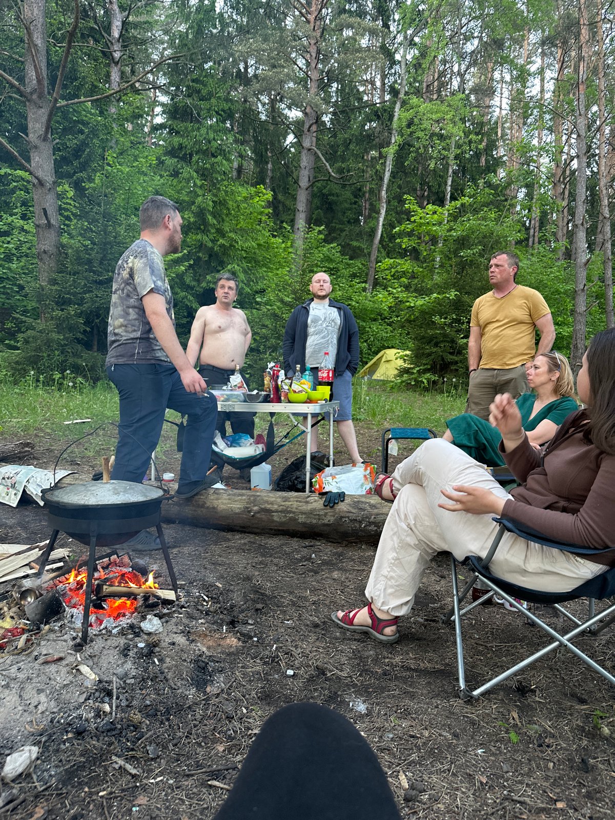 Camping group cooks outdoors in Belarus forest