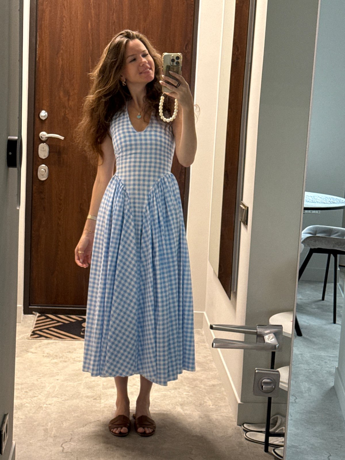 Mirror selfie in a hallway, blue gingham dress