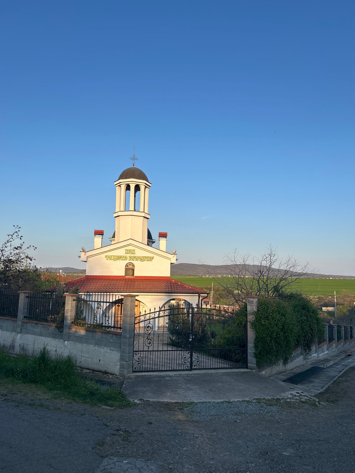Spring blooms observed near white church with red roof
