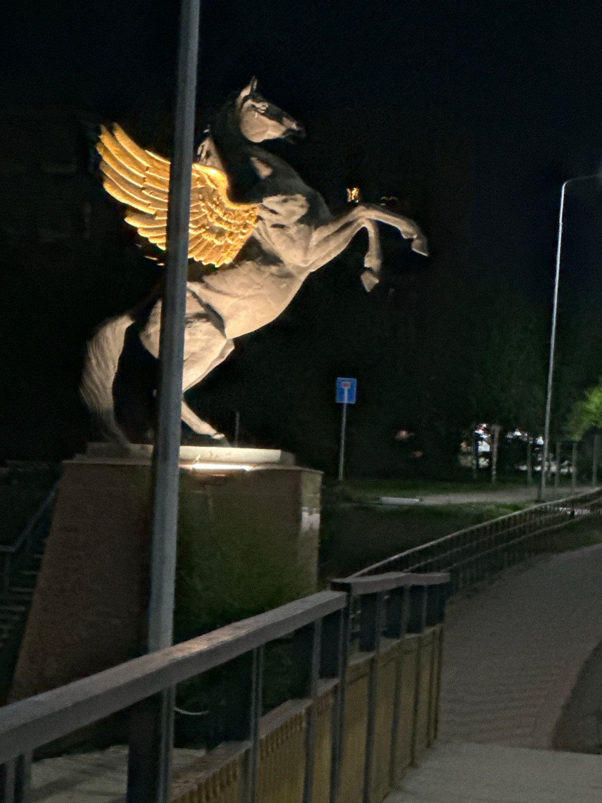 Nighttime stroll past Kostanay's illuminated Pegasus statue and riverside promenade