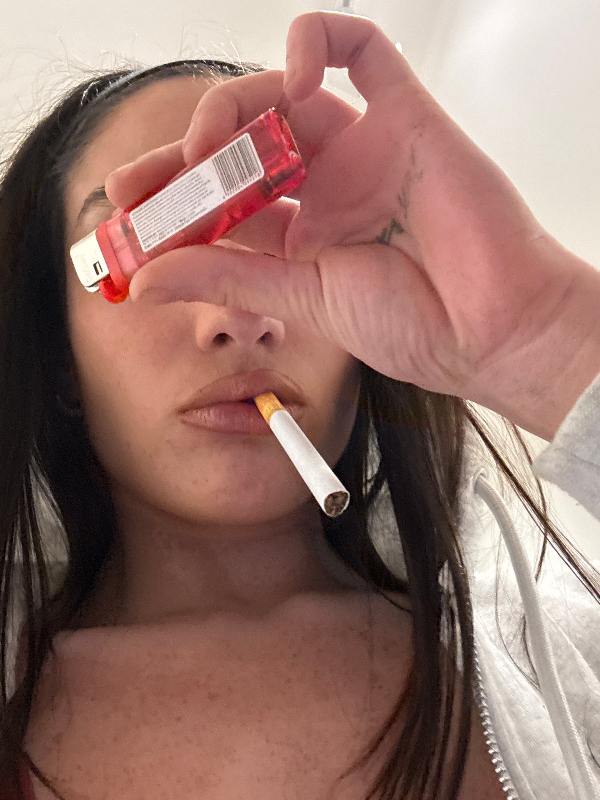Person lights cigarette in Buenos Aires early morning