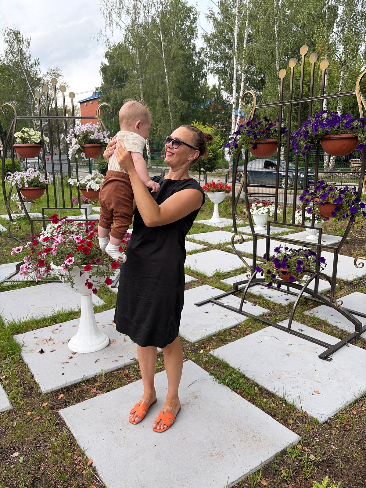 Casual afternoon moments near a flower planter in Chaikovsky
