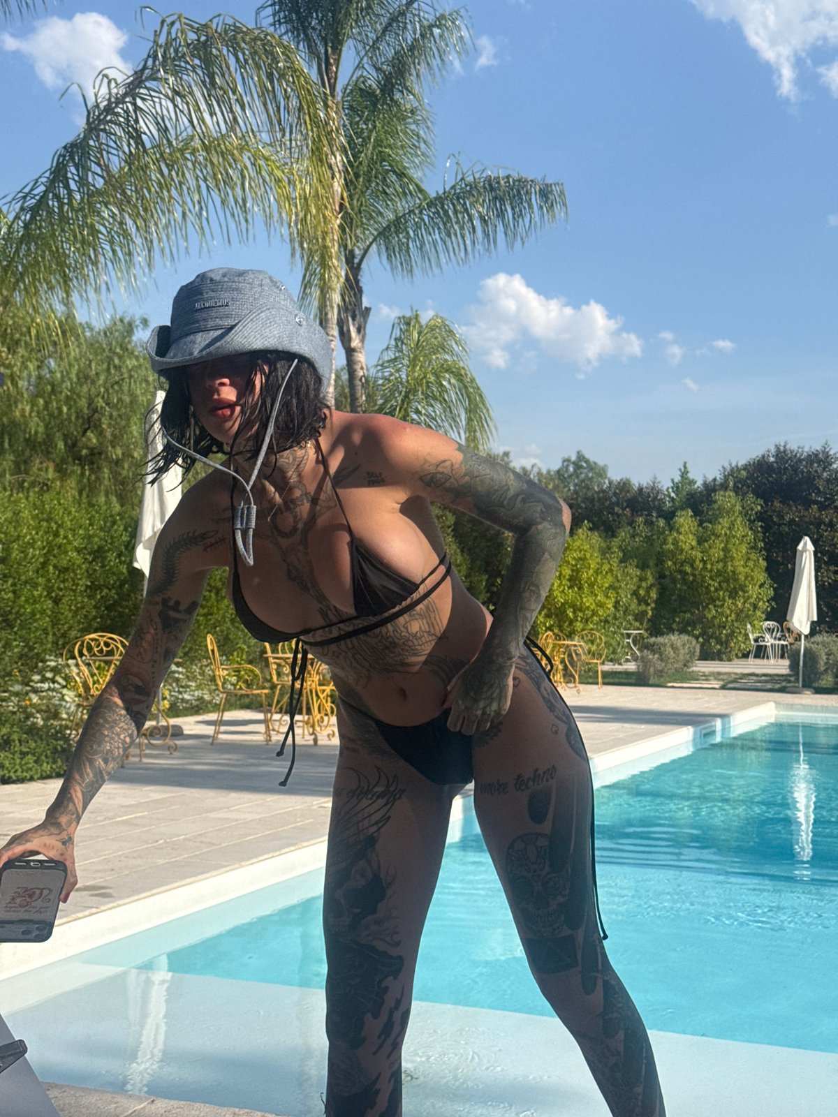Woman takes poolside selfie in Giovinazzo, Italy