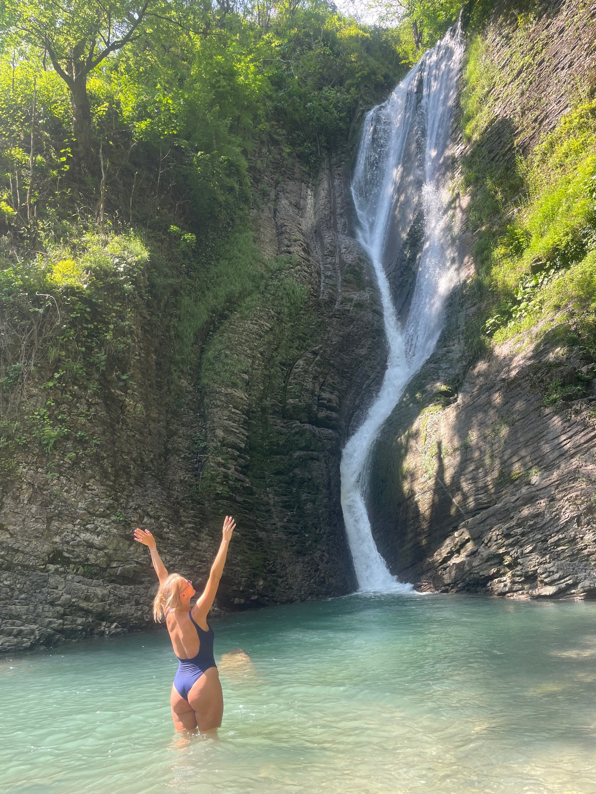 Family visits scenic waterfall destination in Plastunka, Russia