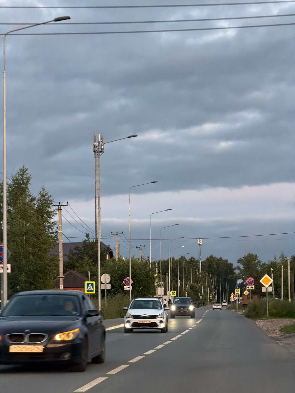 Overcast afternoon traffic on a suburban Kazan roadway