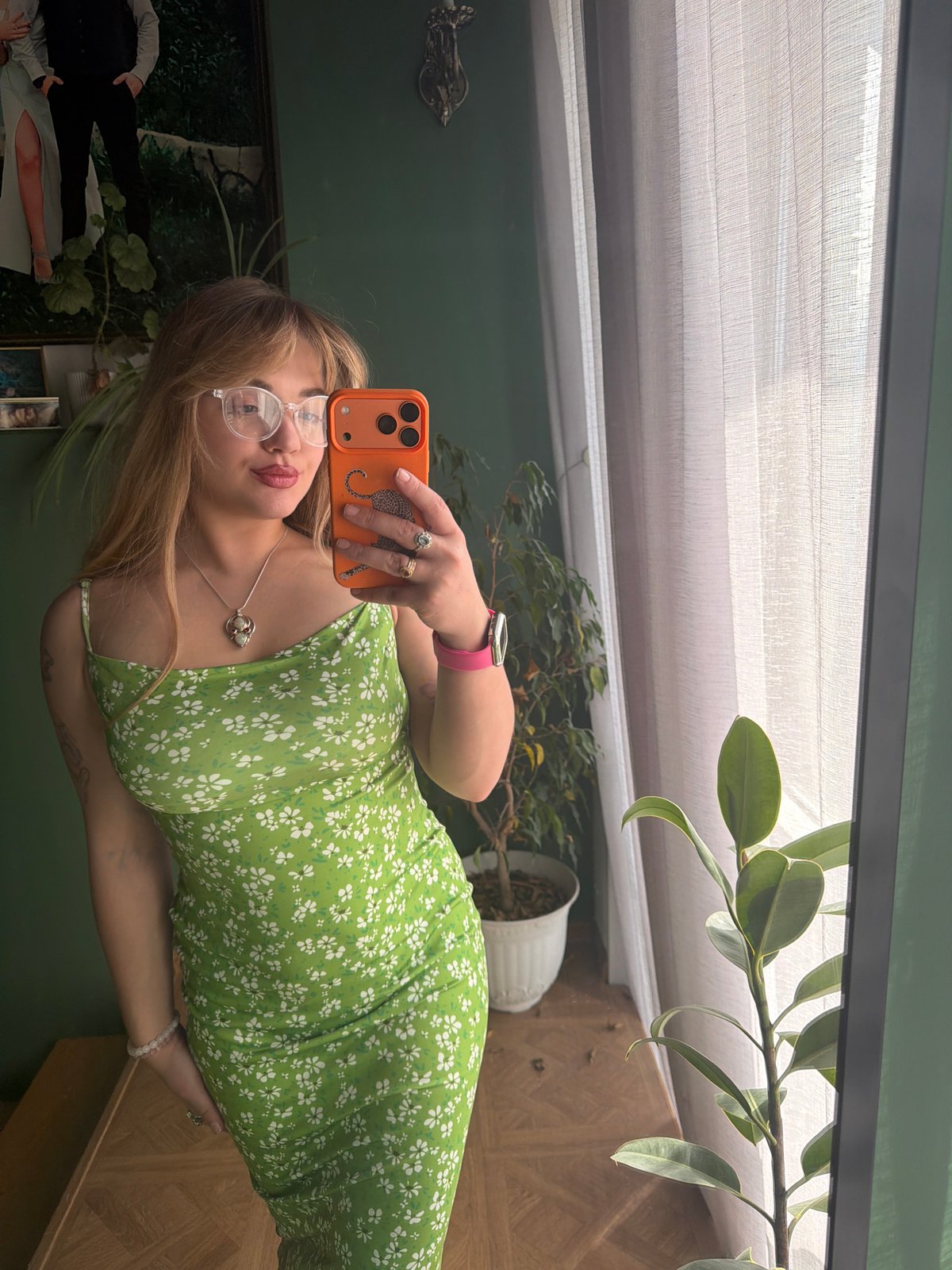 Woman takes selfie series in green dress, Russia