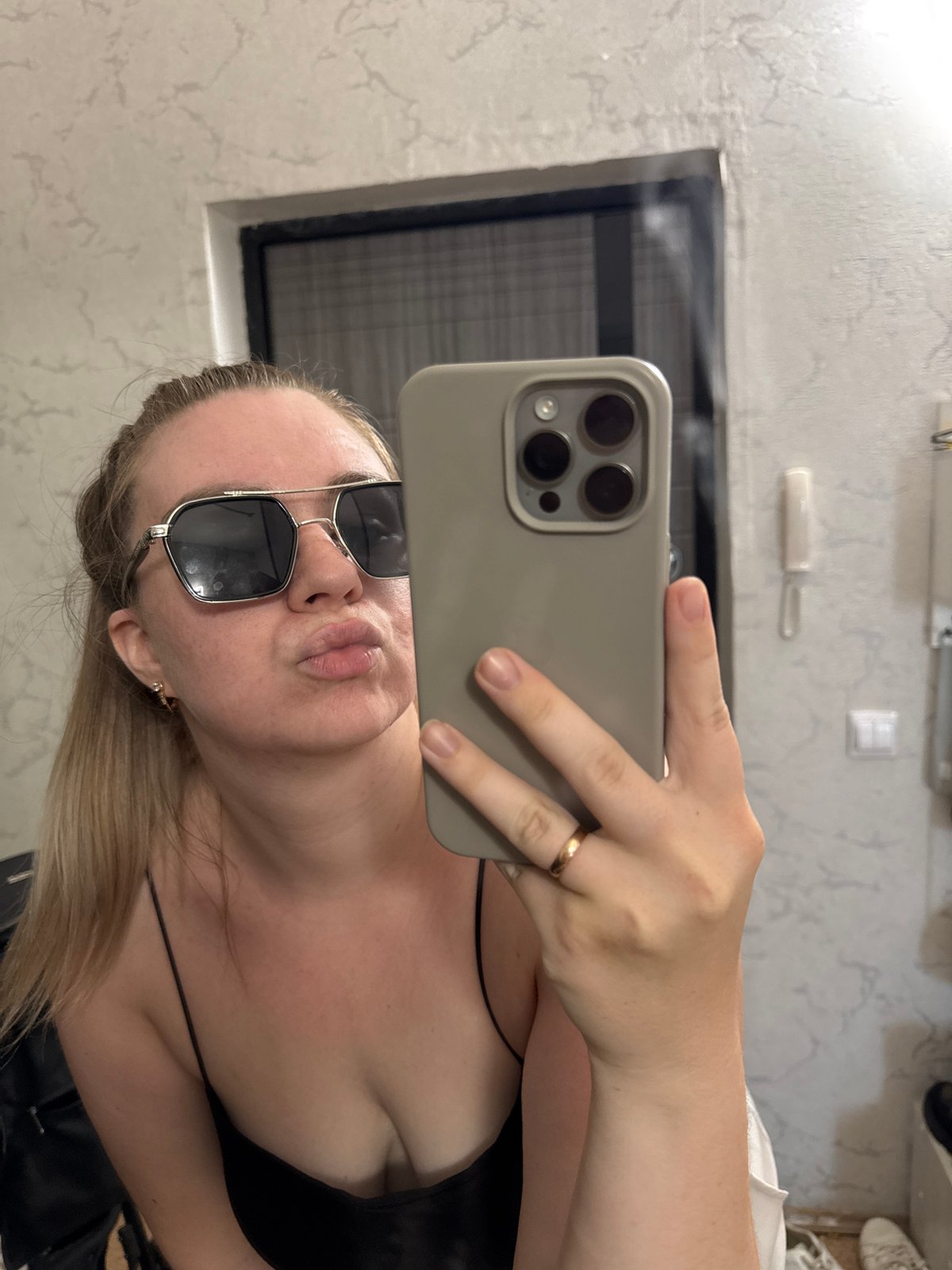 Woman takes mirror selfie in Chaikovsky apartment