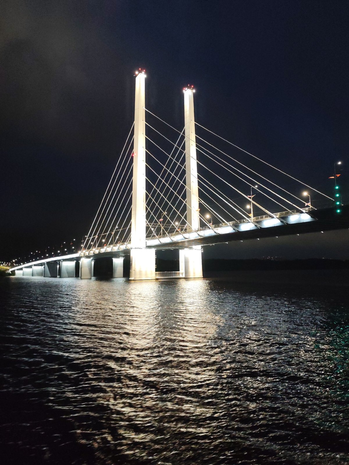 Nighttime bridge and waterfront infrastructure documented by witness