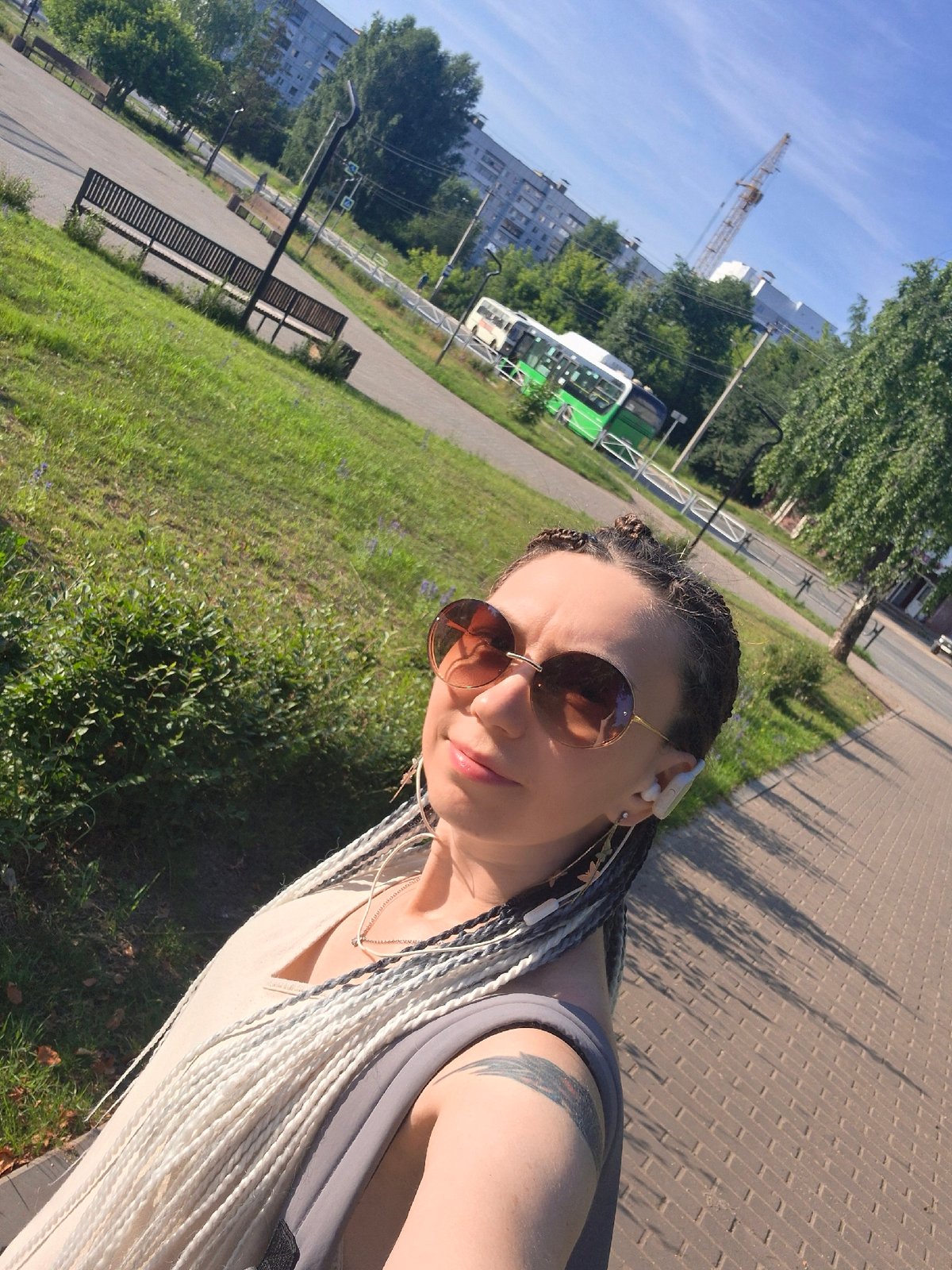 Selfie stop on a sunny urban walkway, peace sign out