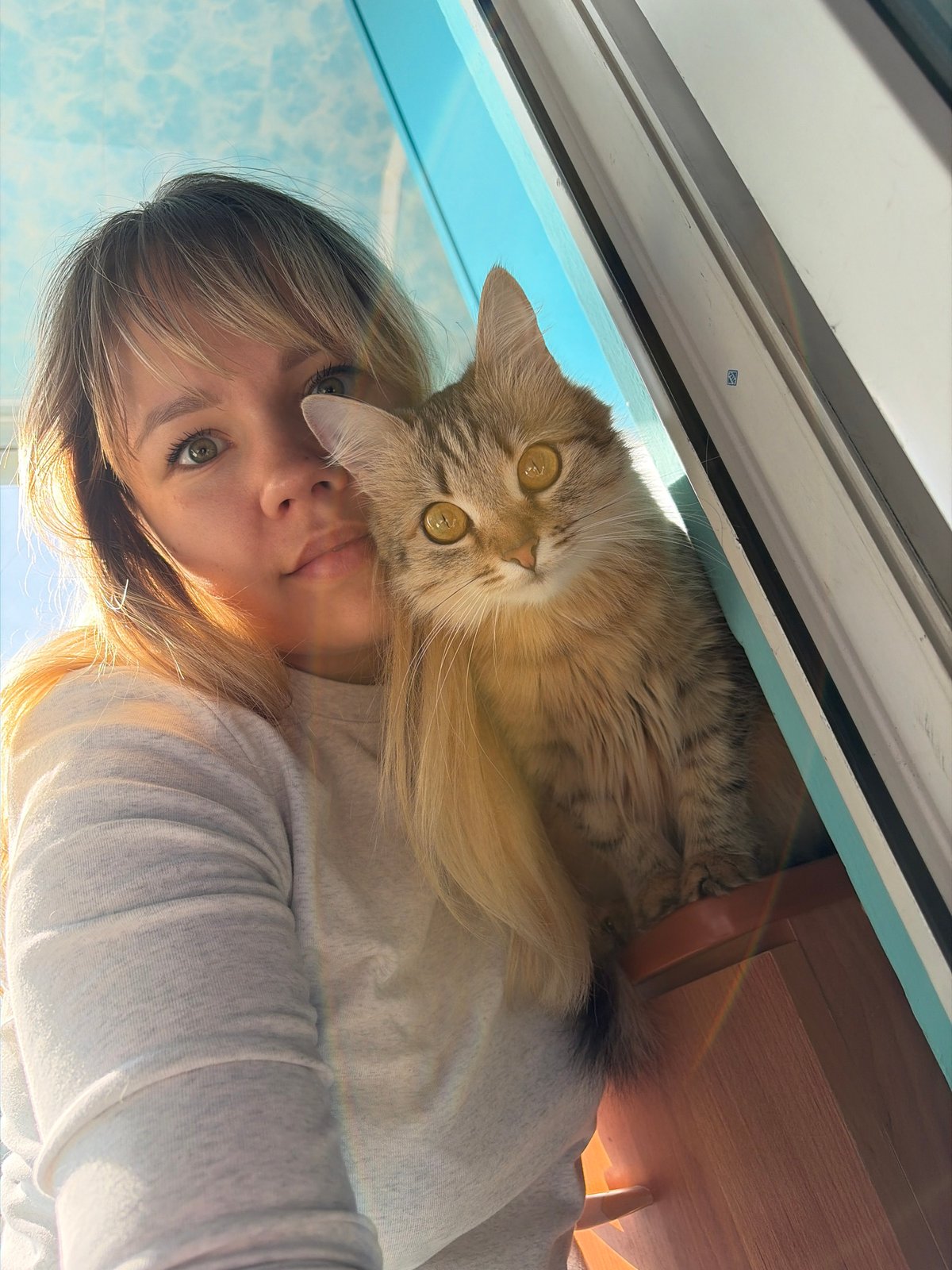 Woman and cats photographed in early morning Chaikovsky home