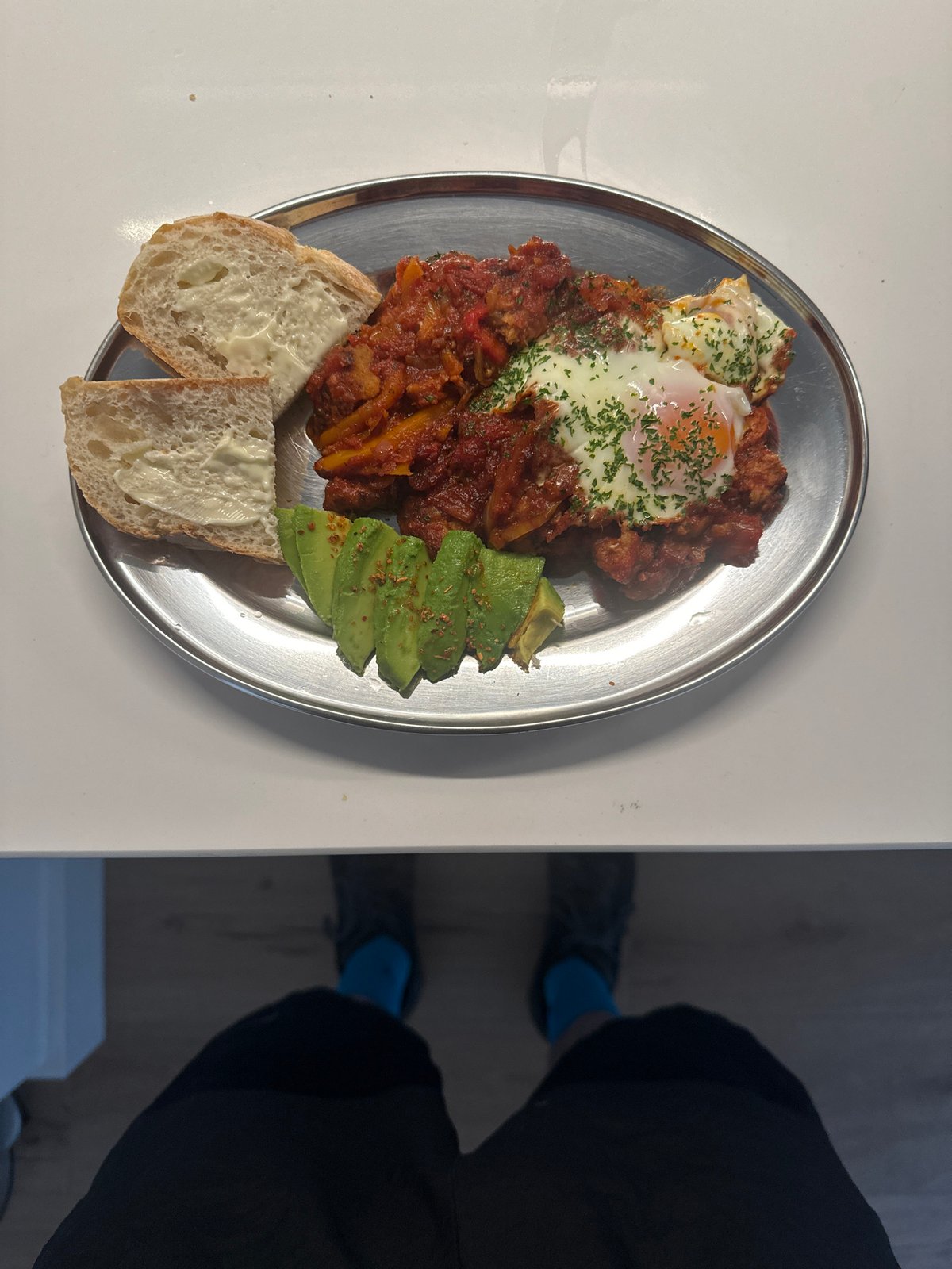 London resident prepares shakshuka breakfast in home kitchen