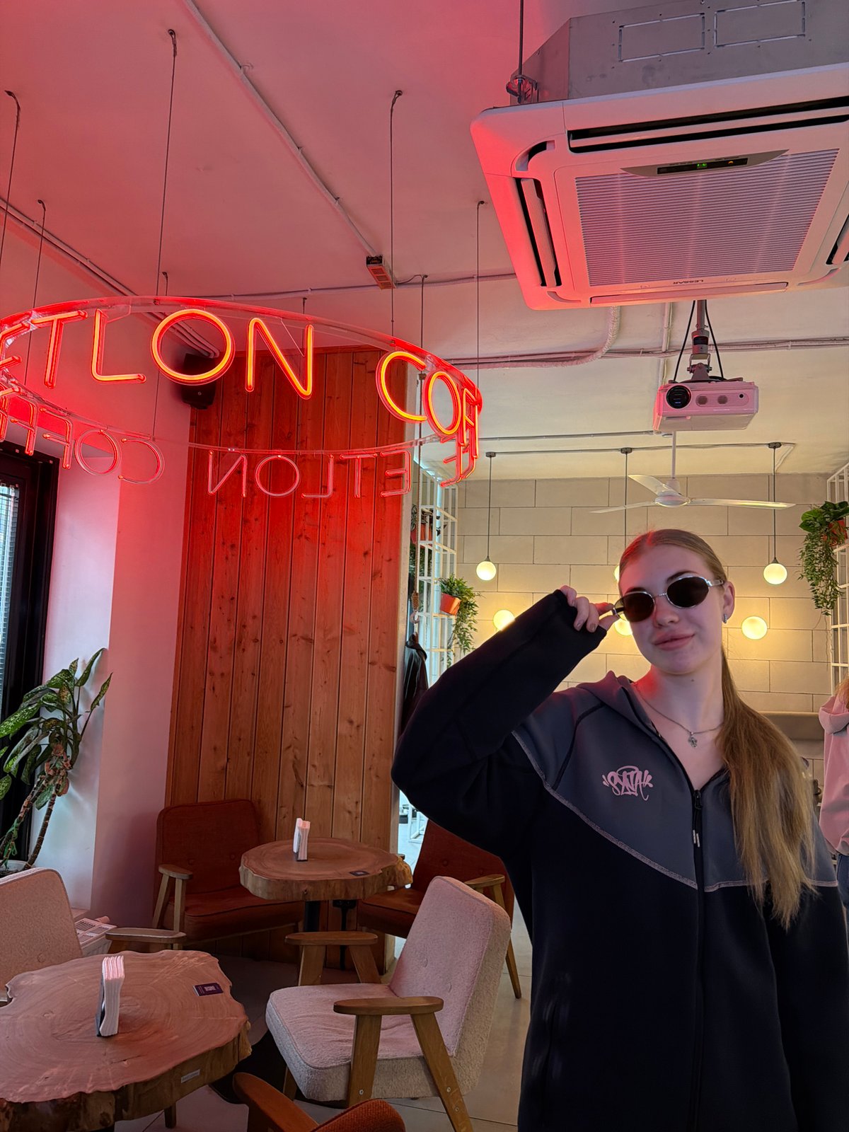 Quick pause at a Shushary cafe, sunglasses adjusted