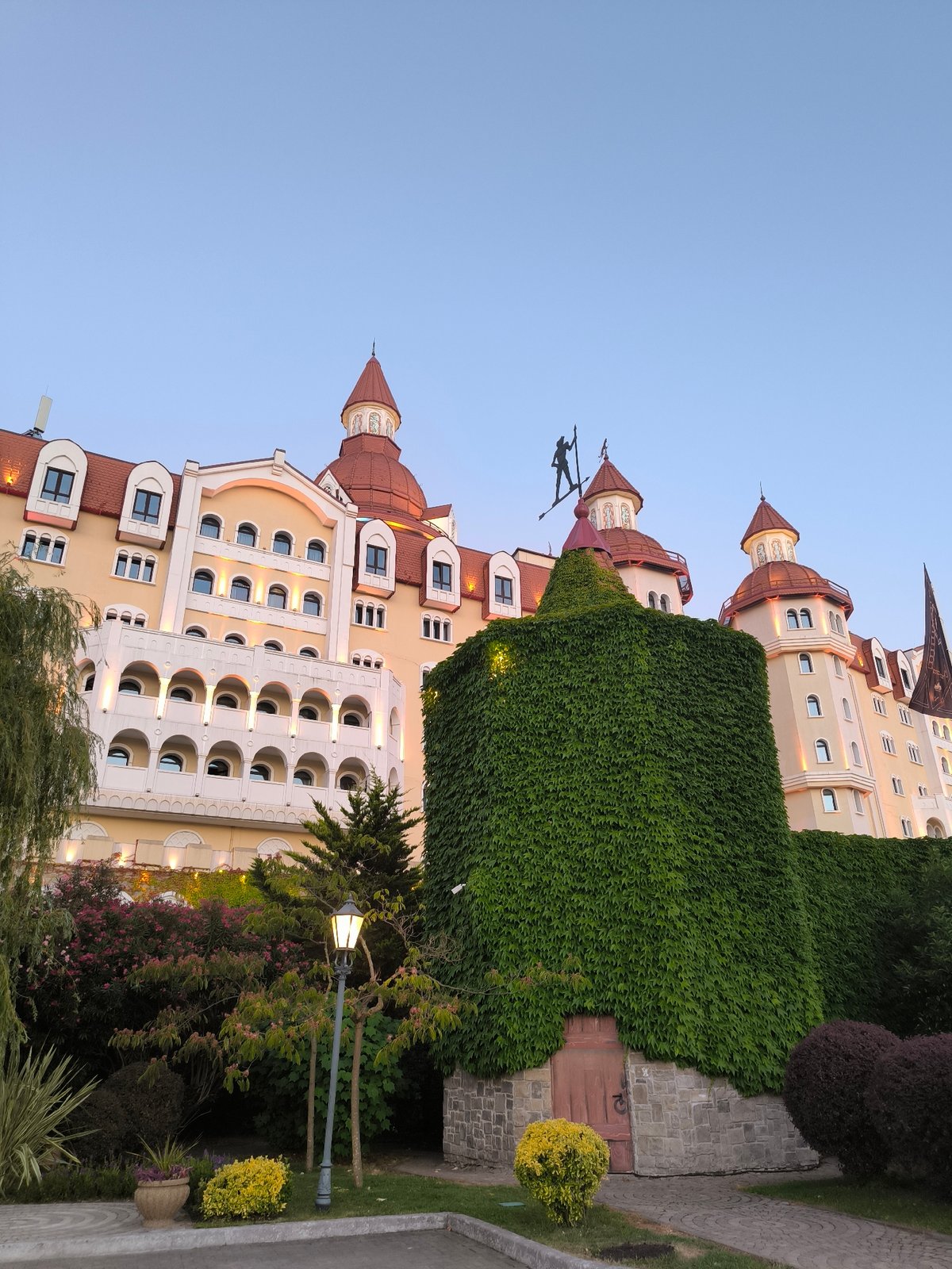 Fairytale castle resort district glows at dusk in Sirius, Russia