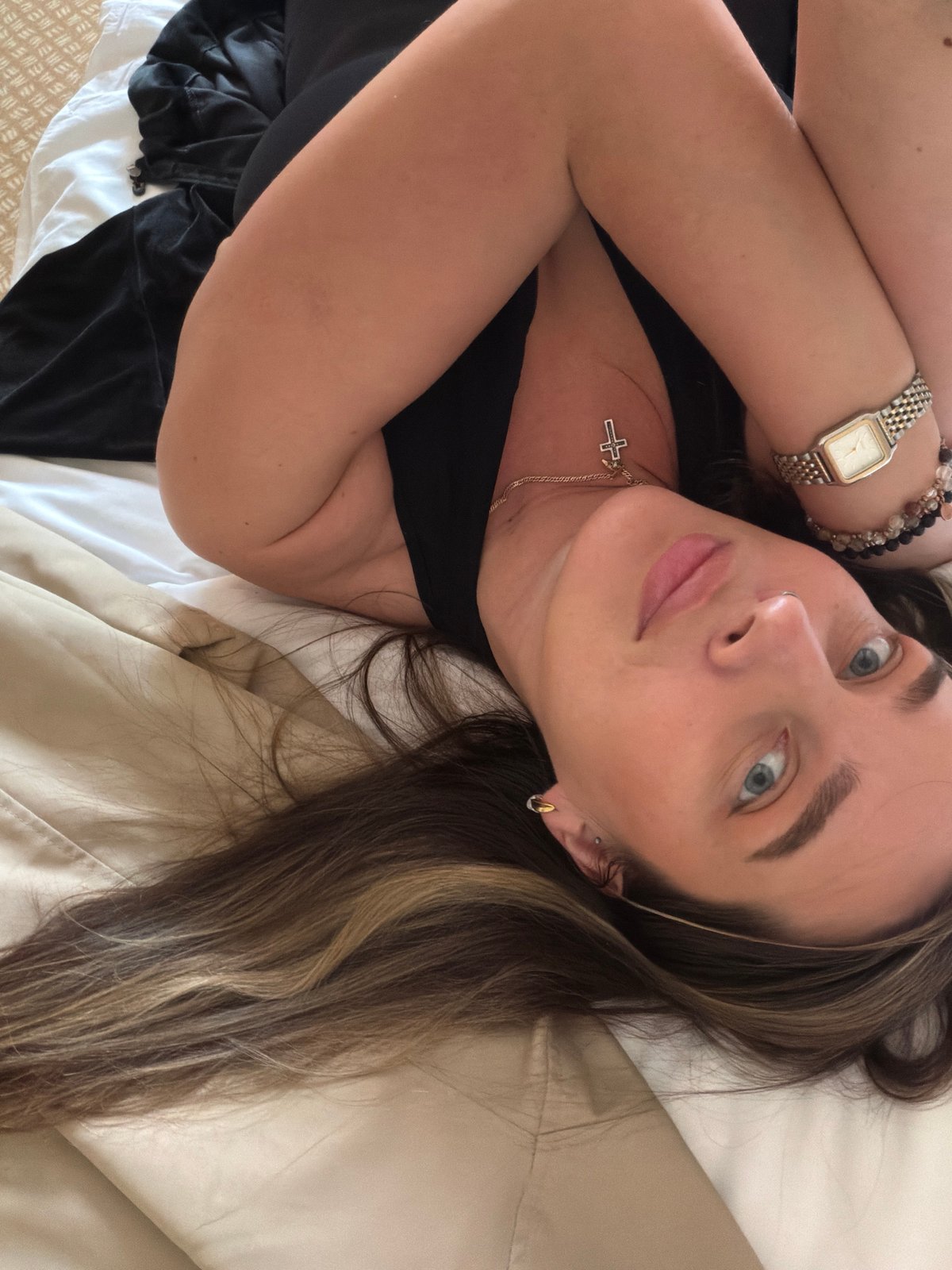 Woman resting on bed captured in elevated angle observation