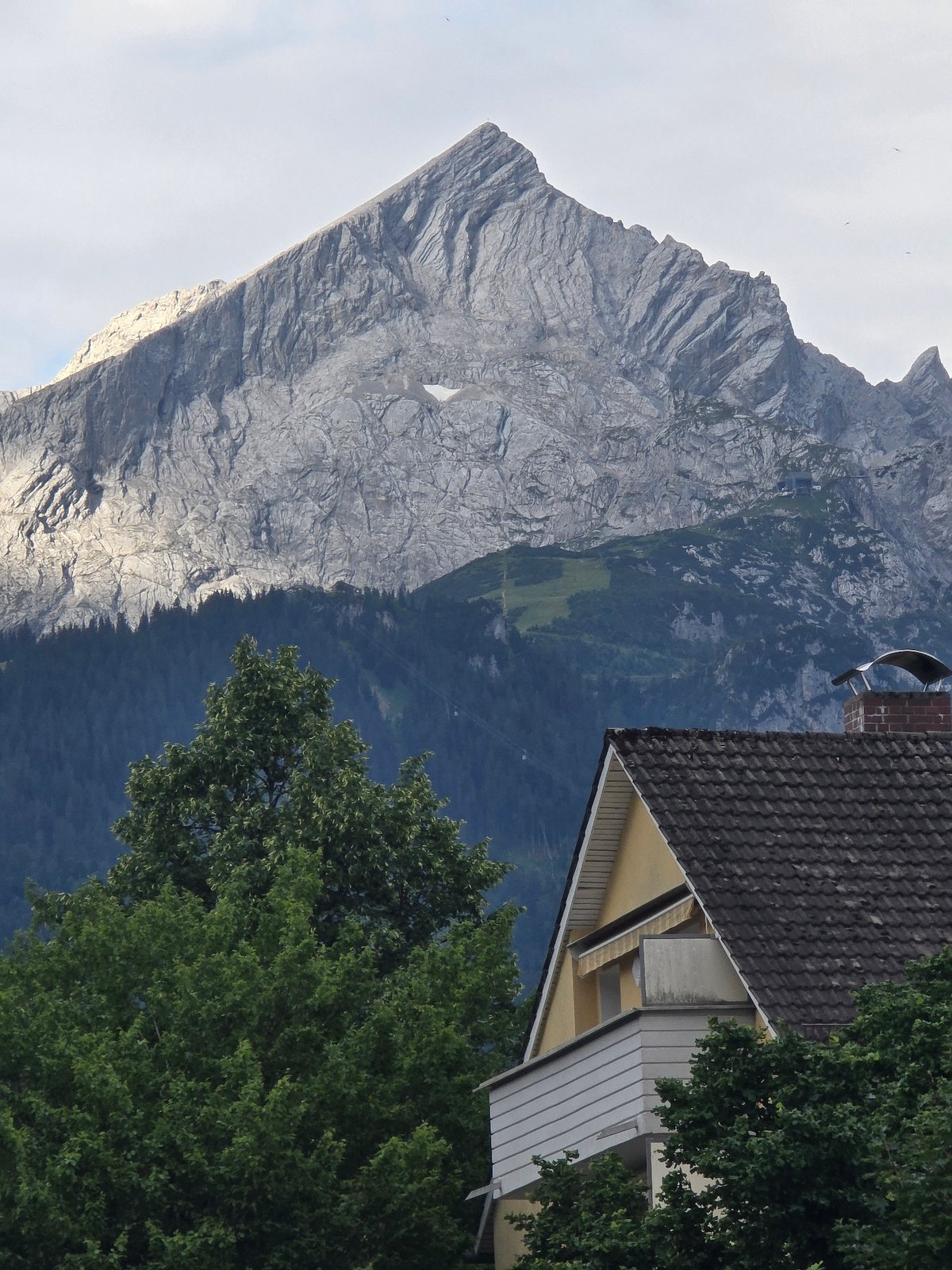 Rooftops and alpine peaks in Garmisch-Partenkirchen on a July morning