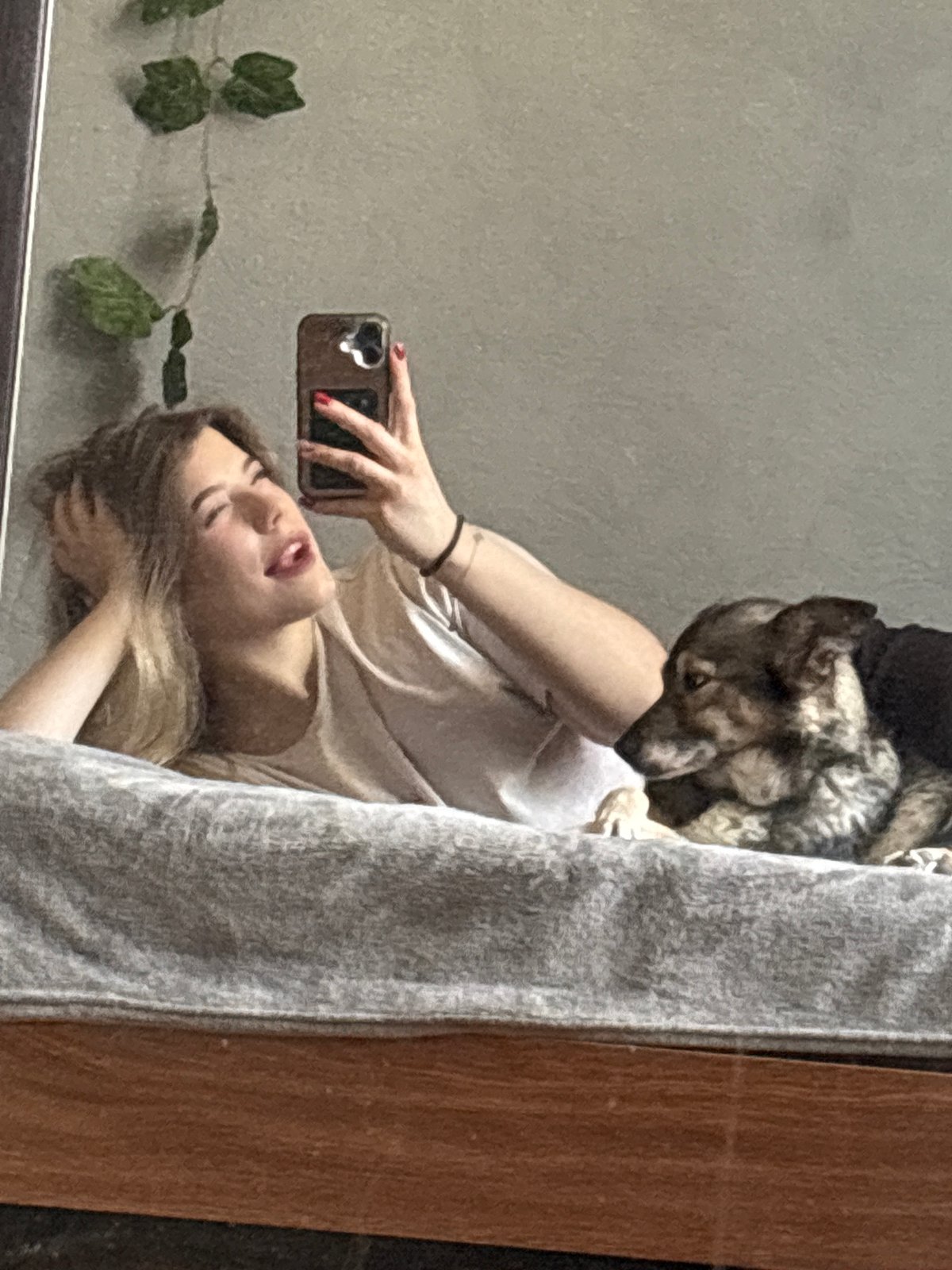 Bedroom selfie session with dog companion