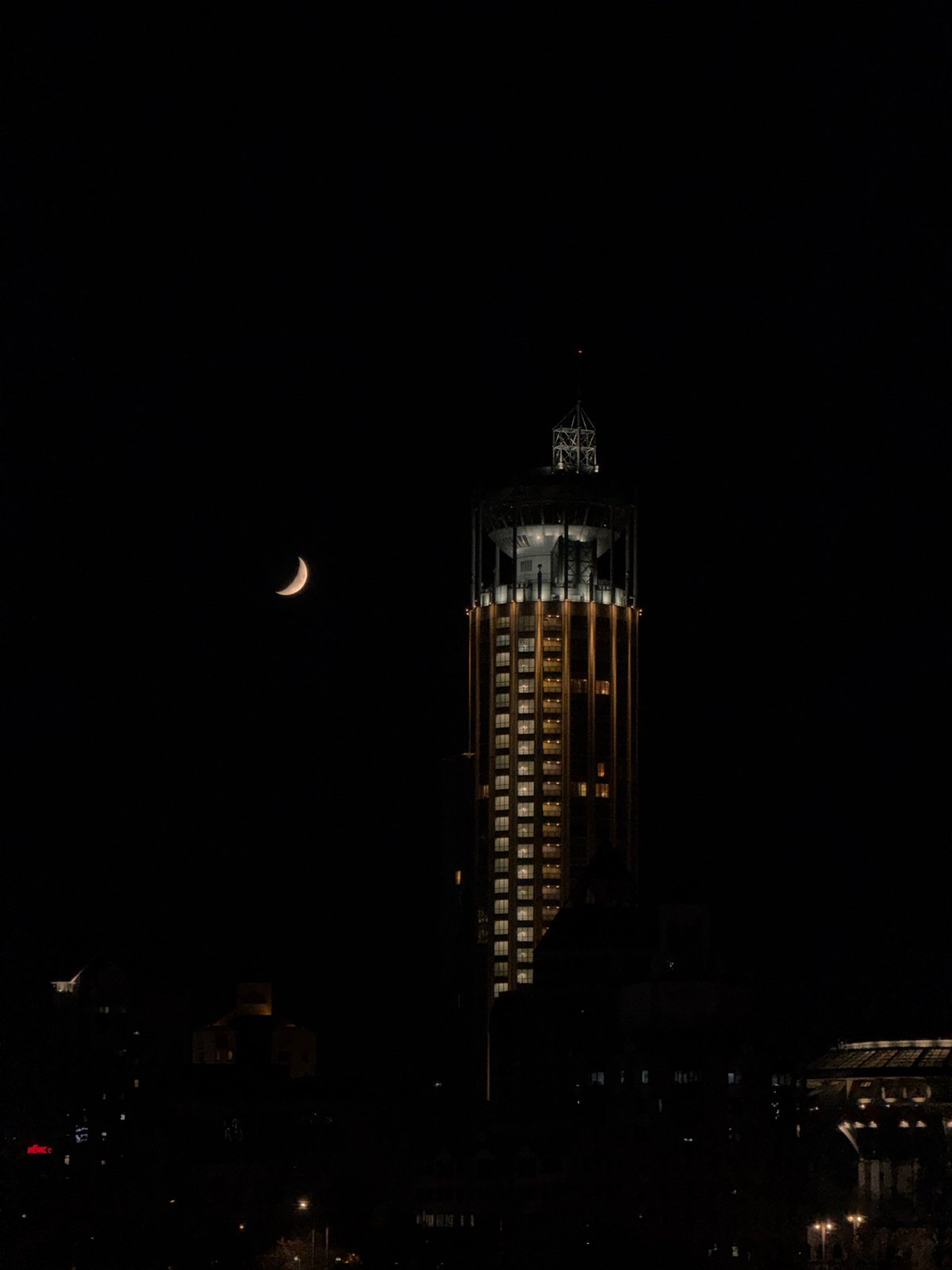 Illuminated building photographed against Moscow night sky