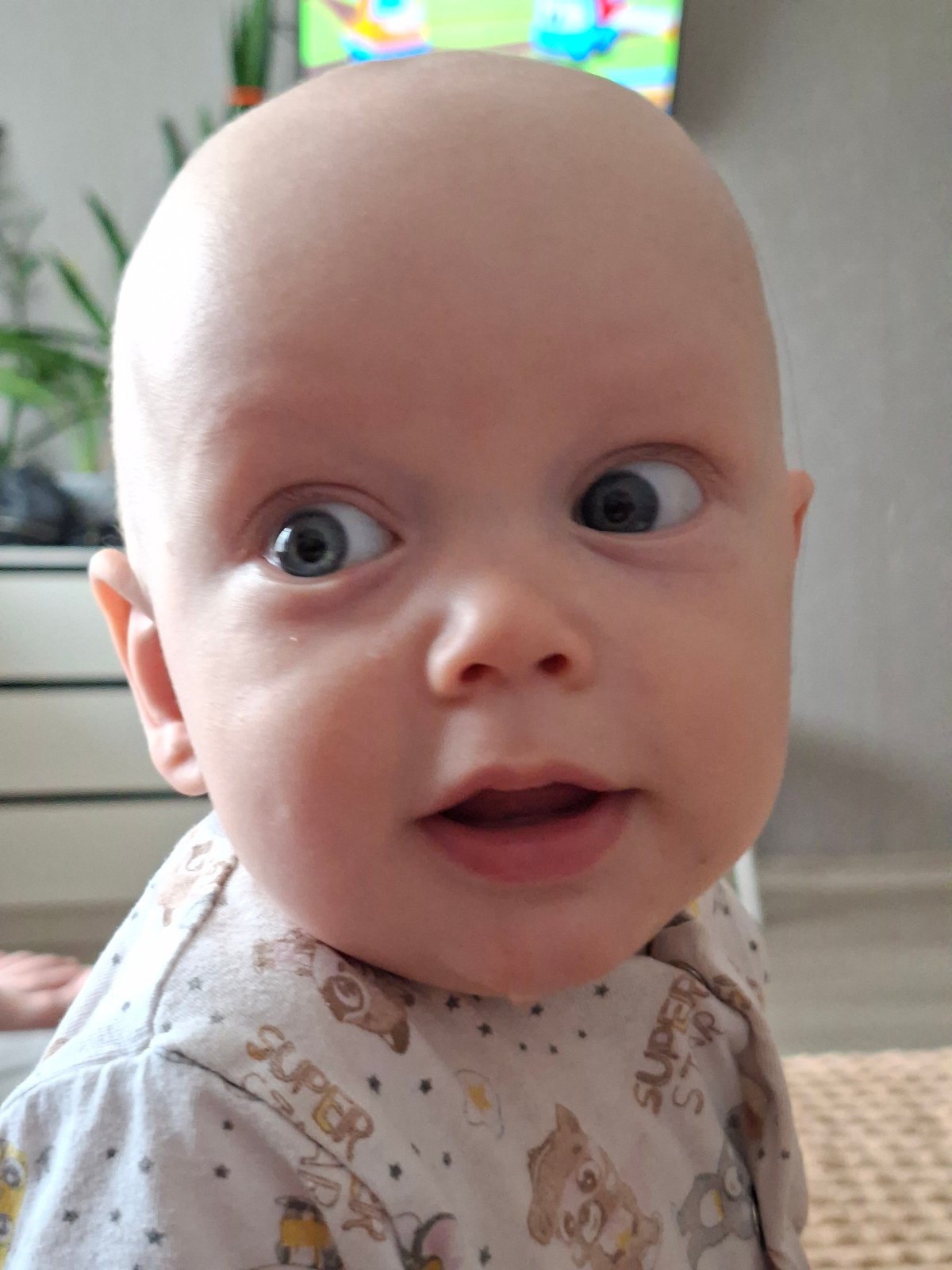 Baby and sibling share snack time and sweet moments indoors