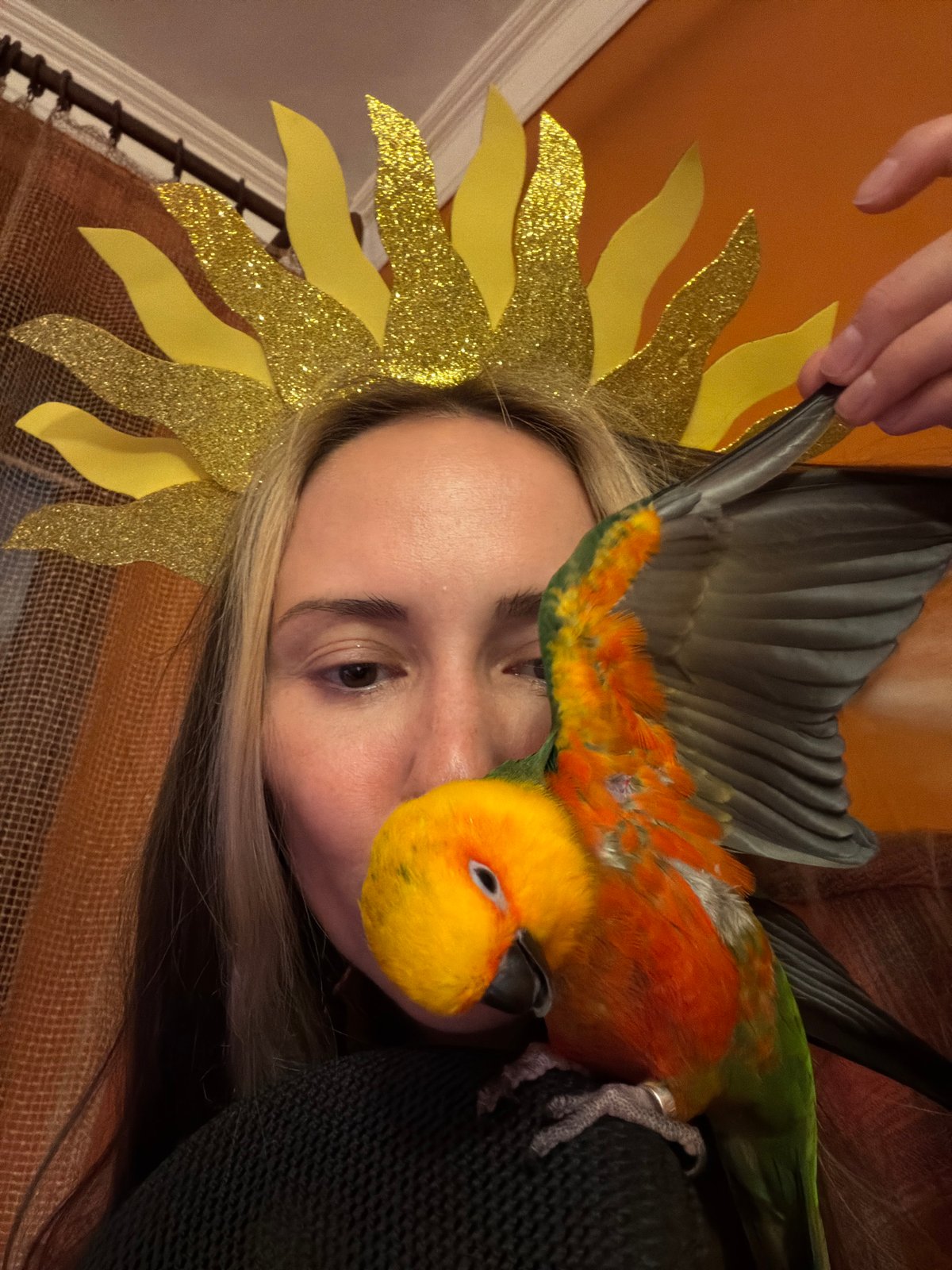 Person poses with pet parrot in Khimki indoor portrait